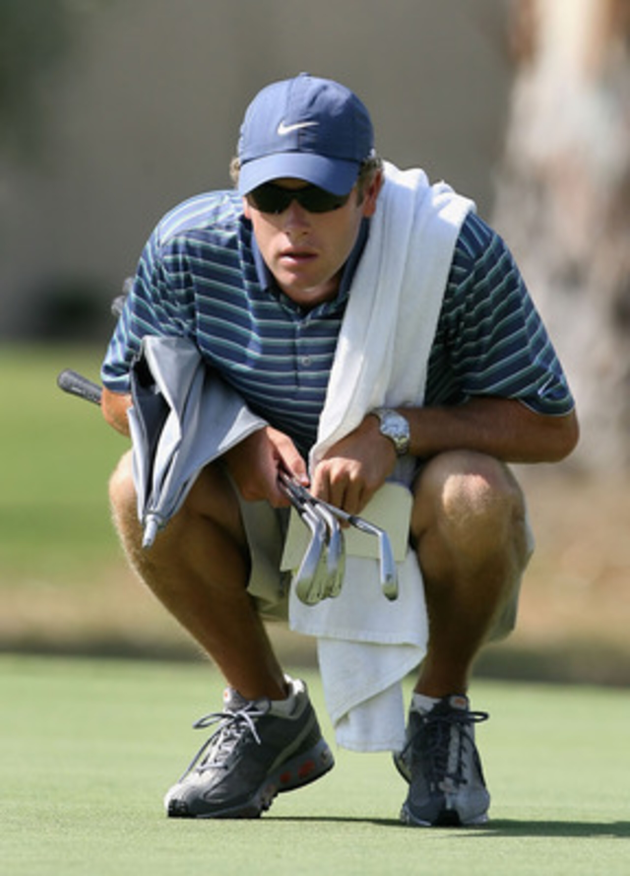 RANCHO MIRAGE, CA - SEPTEMBER 17:  Tim Vickers, caddie to Michelle Wie, examines the thrid hole green during the second round of the LPGA Q-School Sectional Qualifying at Mission Hills Country Club on September 17, 2008 in Rancho Mirage, California.  (Pho