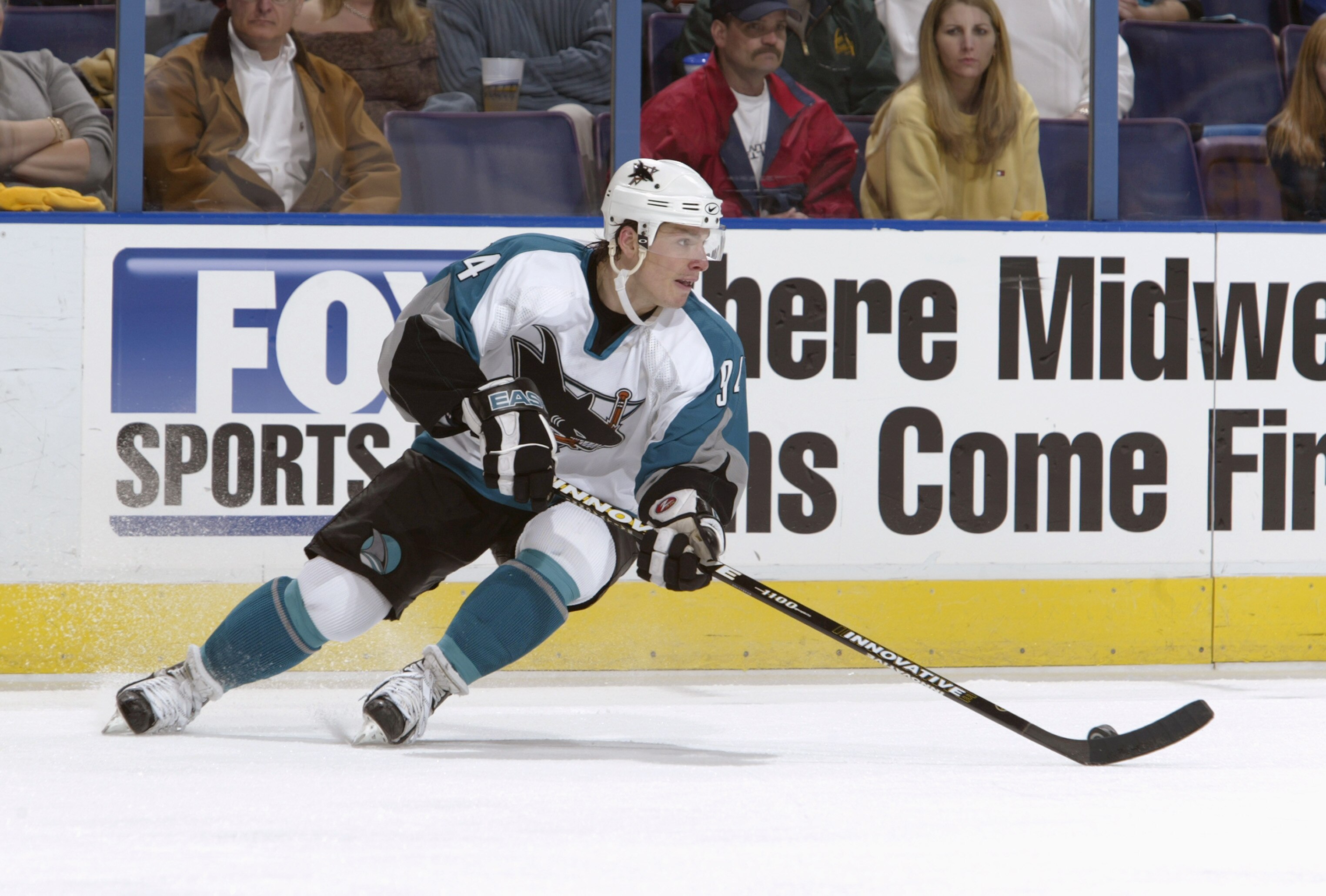 ST. LOUIS - APRIL 12:  Alex Korolyuk #94 of the San Jose Sharks looks up the ice as he circles with the puck against the St. Louis Blues in game three of the Western Conference Quarterfinals on April 12, 2004 at the Savvis Center in St. Louis, Missouri.