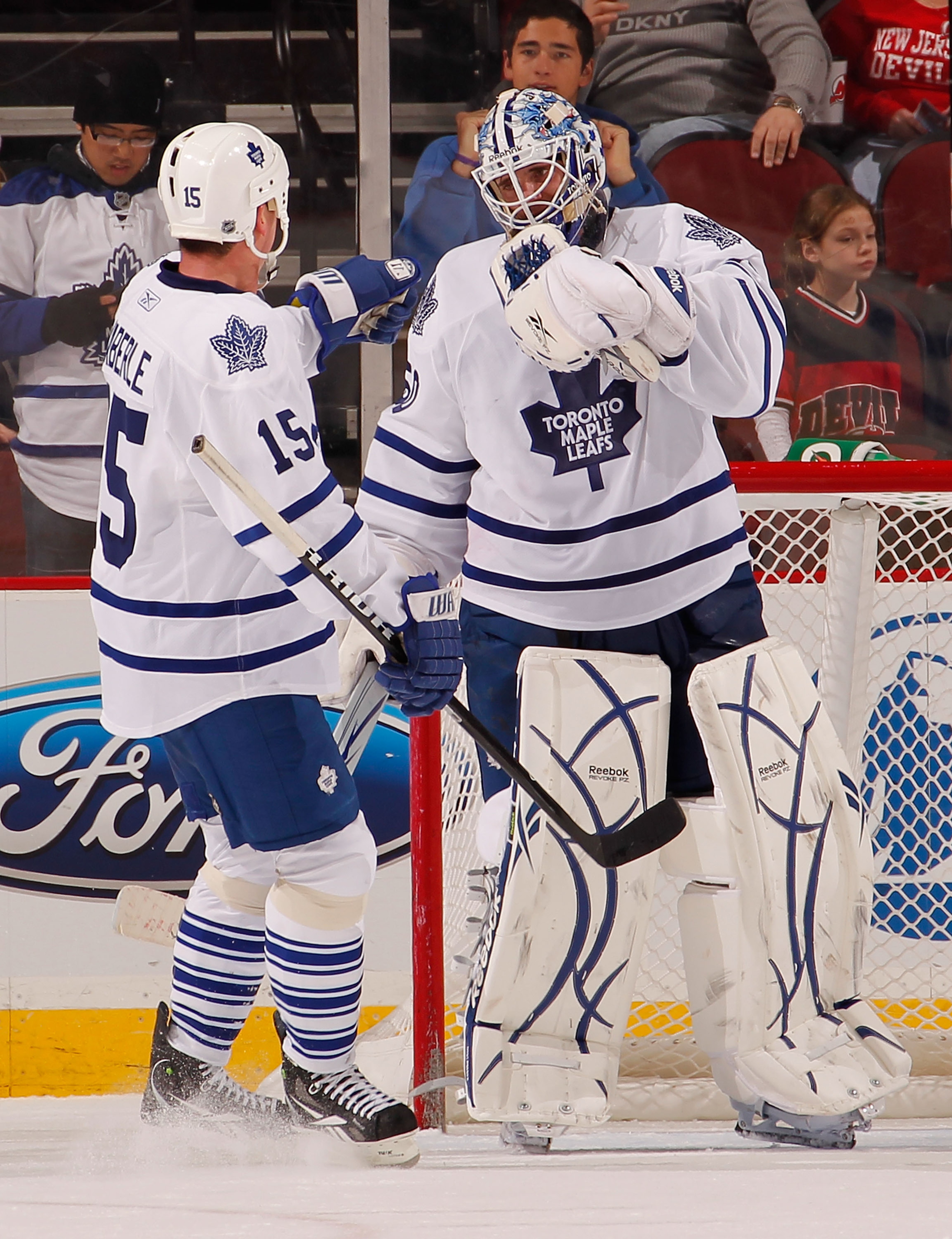 NEWARK, NJ - DECEMBER 26:  Goalie Jonas Gustavsson #50 of the Toronto Maple Leafs gets congratulations from Tomas Kaberle #15 of the Leafs after a win over the New Jersey Devils in an NHL hockey game at the Prudential Center on December 26, 2010 in Newark
