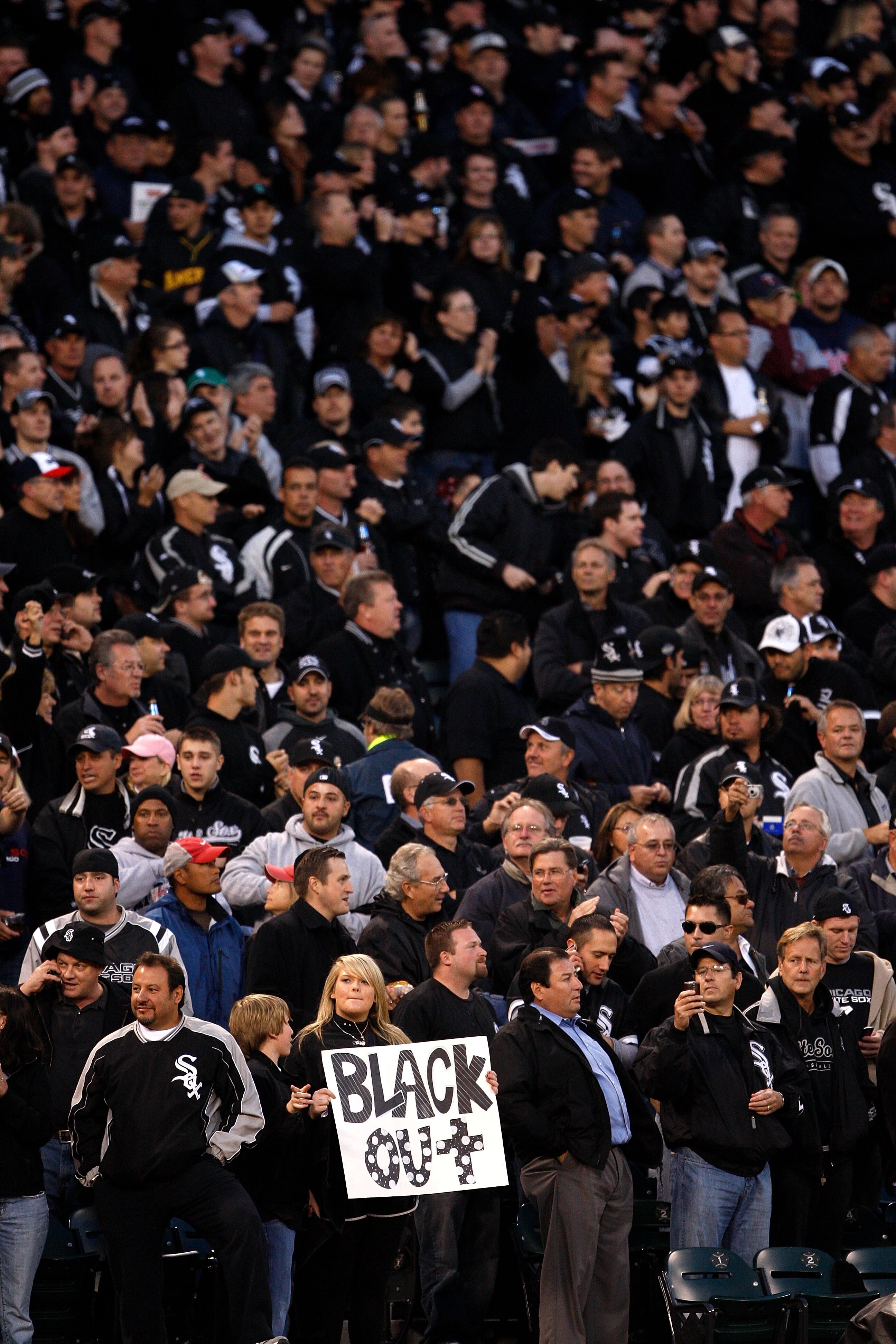 CHICAGO - SEPTEMBER 30:  A fan of the Chicago White Sox holds up a sign which reads 'Black out' in reference to all the fans wearing black for the game against the Minnesota Twins during the American League Central Division Tiebreaker game at U.S. Cellula