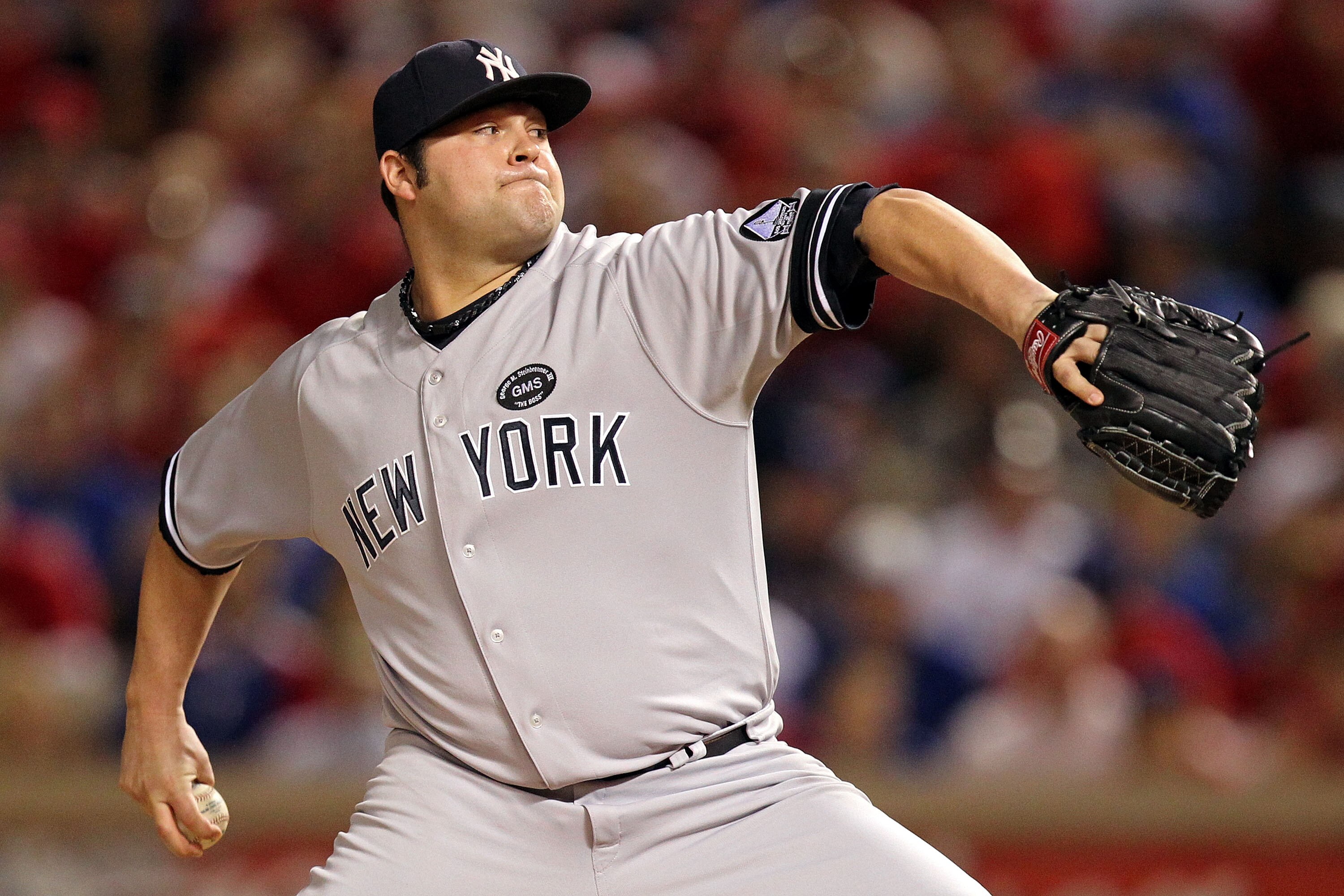 ARLINGTON, TX - OCTOBER 15:  Joba Chamberlain #62 of the New York Yankees throws a pitch against the Texas Rangers in Game One of the ALCS during the 2010 MLB Playoffs at Rangers Ballpark in Arlington on October 15, 2010 in Arlington, Texas.  (Photo by Ro