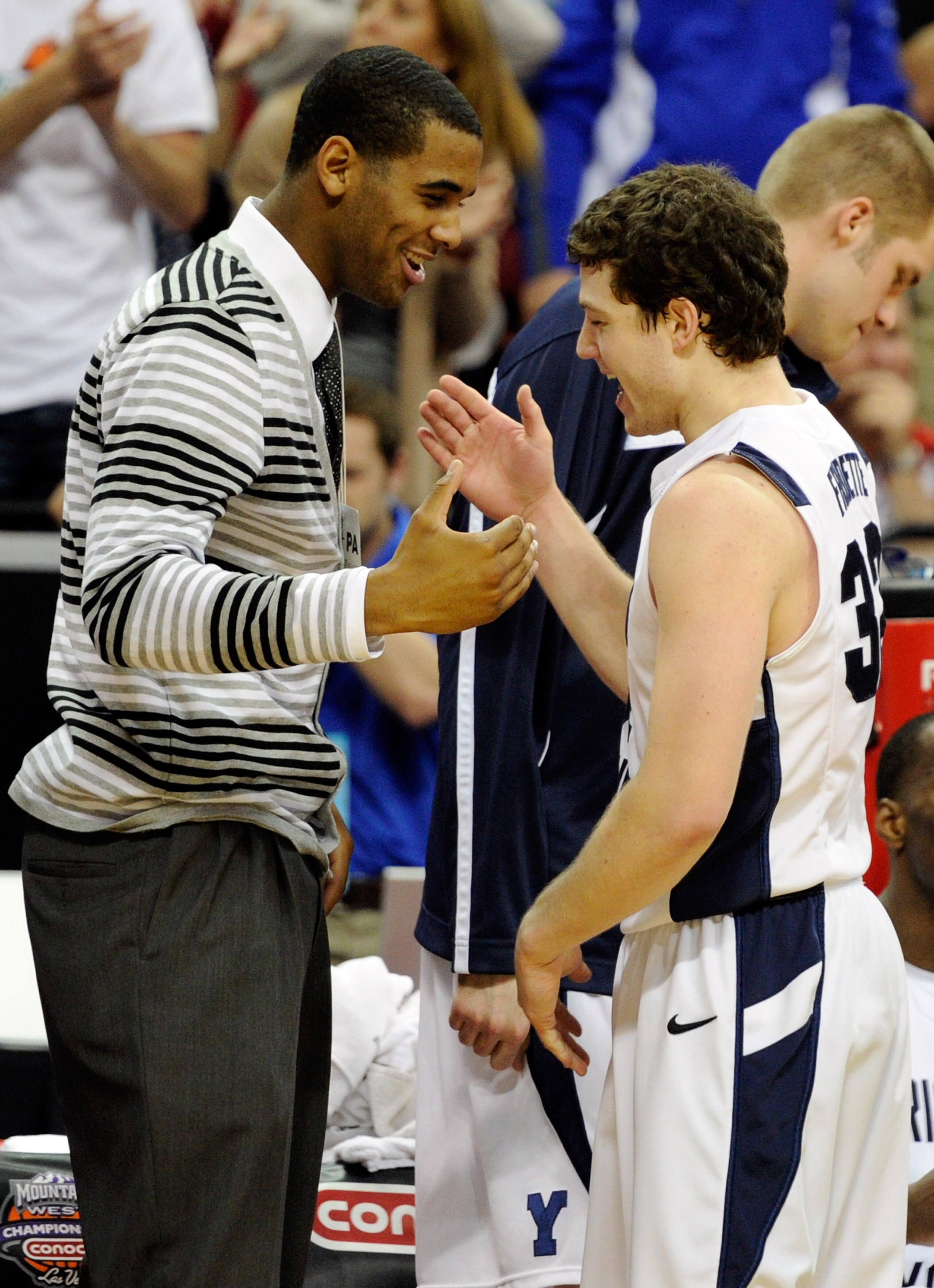 LAS VEGAS, NV - MARCH 11: Suspended Brigham Young University Cougars player Brandon Davies (L) greets Jimmer Fredette #32 as he comes out of a semifinal game of the Conoco Mountain West Conference Basketball tournament against the New Mexico Lobos at the LAS VEGAS, NV - MARCH 11: Suspended Brigham Young University Cougars player Brandon Davies (L) greets Jimmer Fredette #32 as he comes out of a semifinal game of the Conoco Mountain West Conference Basketball tournament against the New Mexico Lobos at the