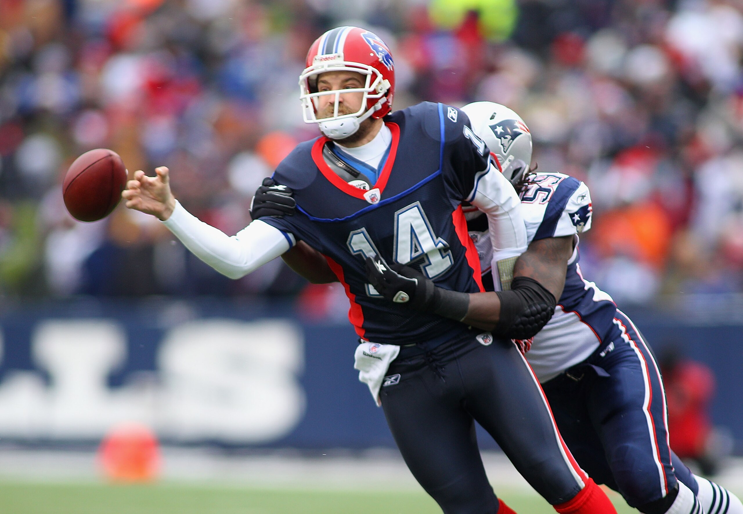 ORCHARD PARK, NY - DECEMBER 26: Ryan Fitzpatrick #14 of the Buffalo Bills fumbles as he is hit by Gary Guyton #59 of the New England Patriots at Ralph Wilson Stadium on December 26, 2010 in Orchard Park, New York.  (Photo by Rick Stewart/Getty Images)