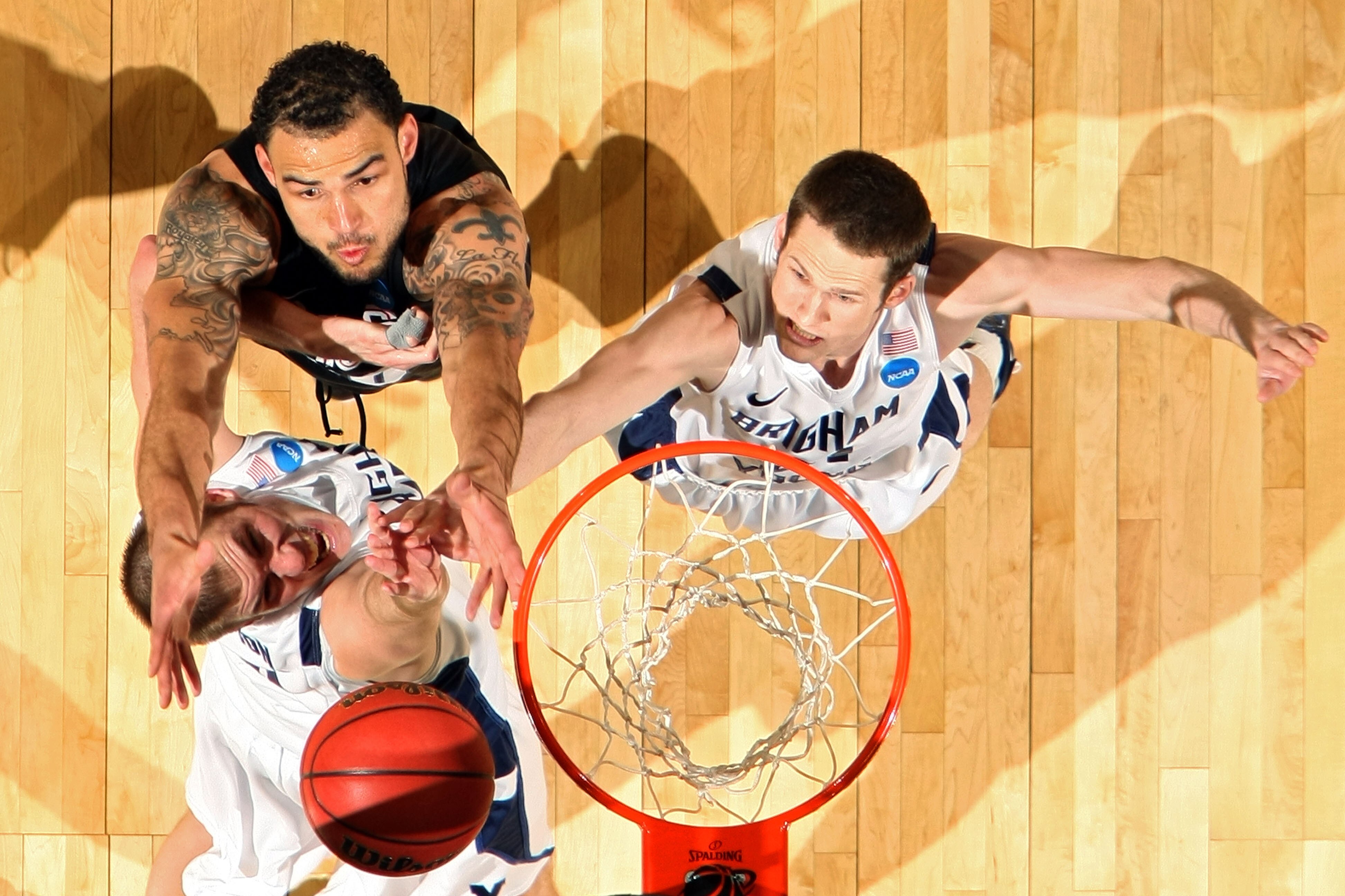 DENVER, CO - MARCH 19:  Robert Sacre #0 of the Gonzaga Bulldogs fights for a rebound against James Anderson #15 and Stephen Rogers #21 of the Brigham Young Cougars during the third round of the 2011 NCAA men's basketball tournament at Pepsi Center on Marc