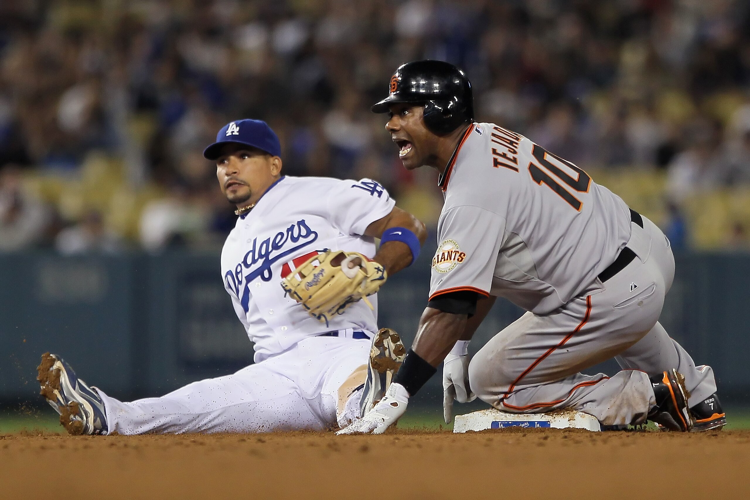 LOS ANGELES, CA - APRIL 01:  Miguel Tejada (R) #10 of the San Francisco Giants reacts after being forced out at second base by shortstop Rafael Furcal #15 of the Los Angeles Dodgers in the seventh inning at Dodger Stadium on April 1, 2011 in Los Angeles,