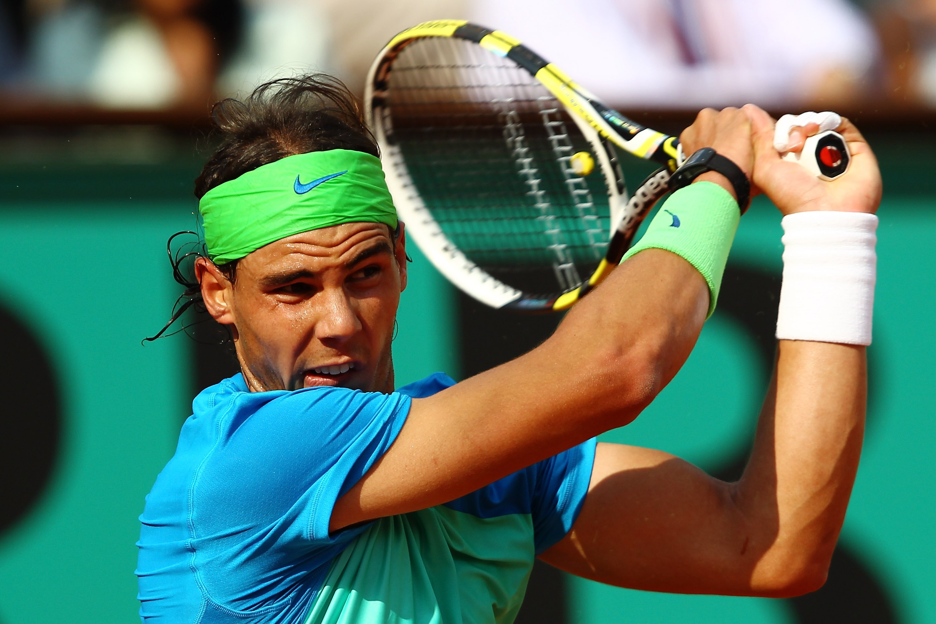 PARIS - JUNE 02:  Rafael Nadal of Spain plays a backhand during the men's singles quarter final match between Rafael Nadal of Spain and Nicolas Almagro of Spain at the French Open on day eleven of the French Open at Roland Garros on June 2, 2010 in Paris,