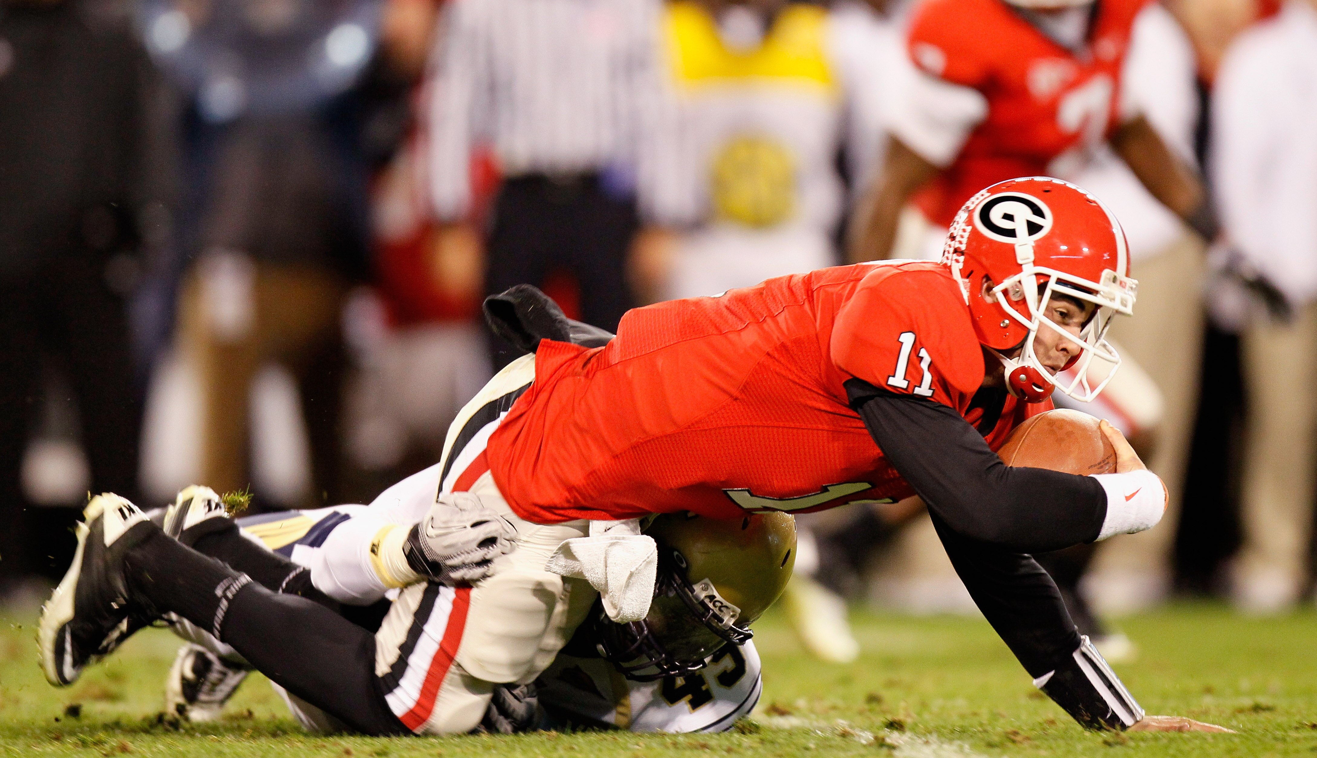 ATHENS, GA - NOVEMBER 27:  Quarterback Aaron Murray #11 of the Georgia Bulldogs is tackled by Jeremiah Attaochu #45 of the Georgia Tech Yellow Jackets at Sanford Stadium on November 27, 2010 in Athens, Georgia.  (Photo by Kevin C. Cox/Getty Images)