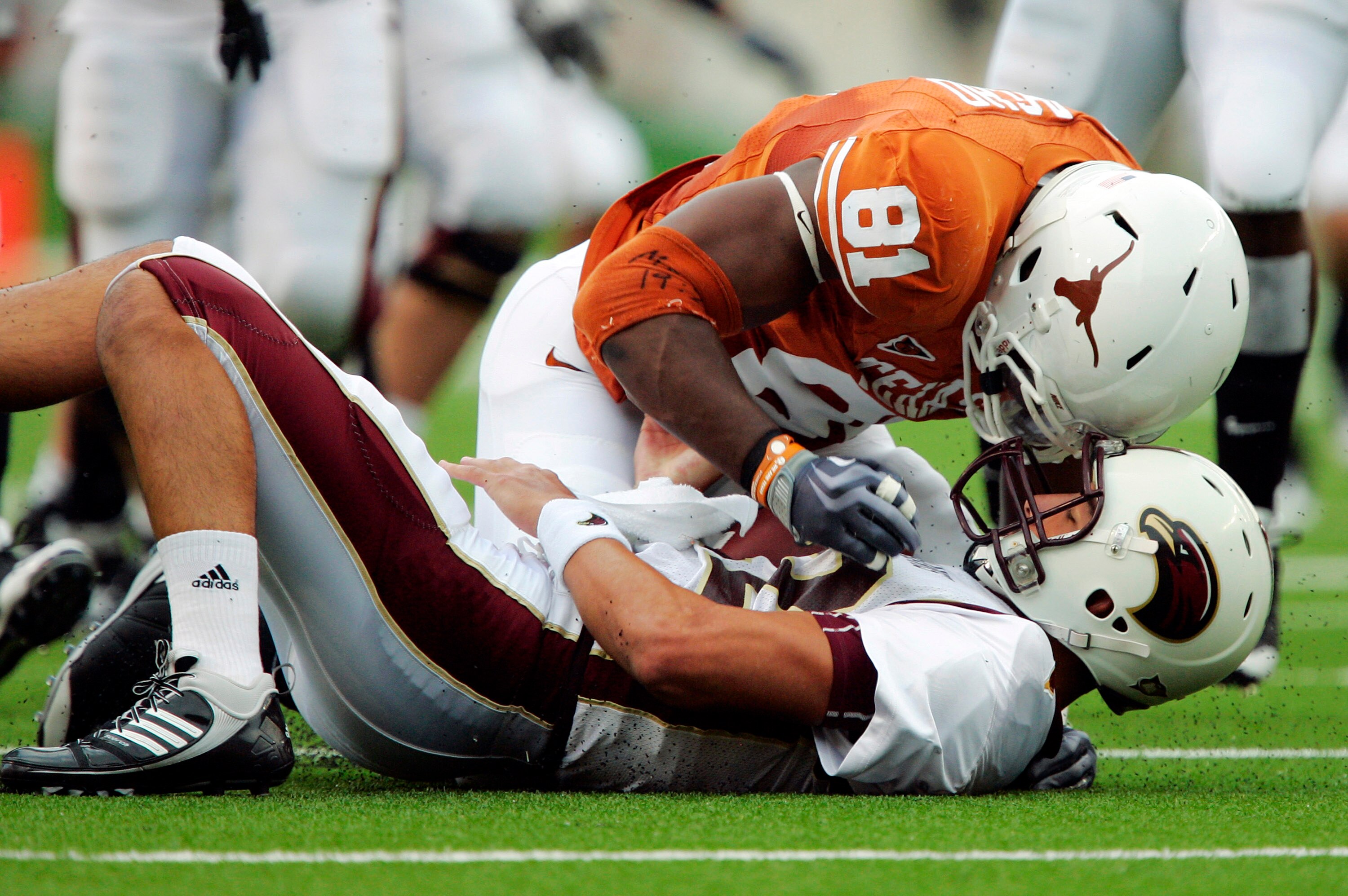 AUSTIN, TX - SEPTEMBER 5:  Defensive end Sam Acho #81 of the Texas Longhorns knocks the ball away from quarterback Trey Revell #12 of the Louisiana Monroe Warhawks for a turnover as he sacks him on September 5, 2009 at Darrell K Royal-Texas Memorial Stadi