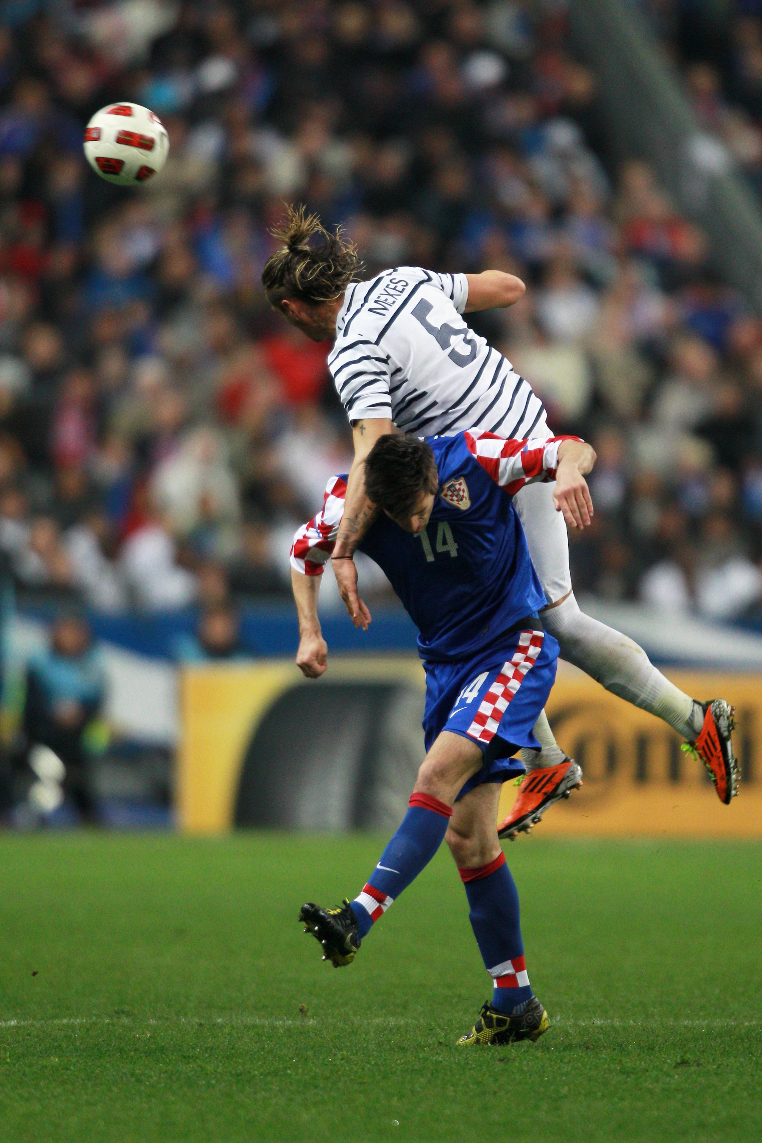 PARIS, FRANCE - MARCH 29:  Philippe Mexes of France beats Nikola Kalinic of Croatia to the header during the International friendly match between France and Croatia at Stade de France at Stade de France on March 29, 2011 in Paris, France.  (Photo by Dean