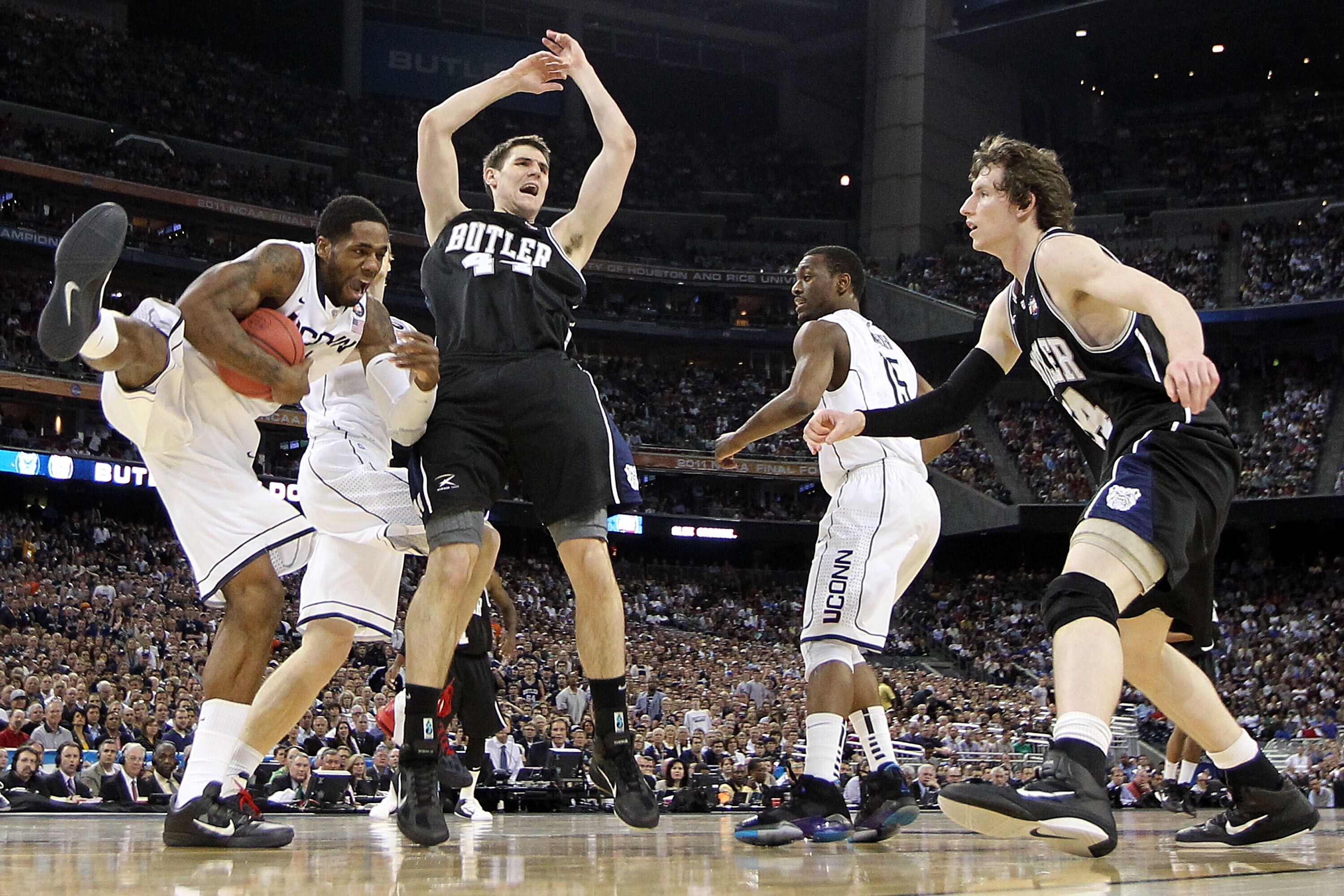 HOUSTON, TX - APRIL 04:  Alex Oriakhi #34 of the Connecticut Huskies grabs a rebound against Andrew Smith #44 and Matt Howard #54 of the Butler Bulldogs during the National Championship Game of the 2011 NCAA Division I Men's Basketball Tournament at Relia