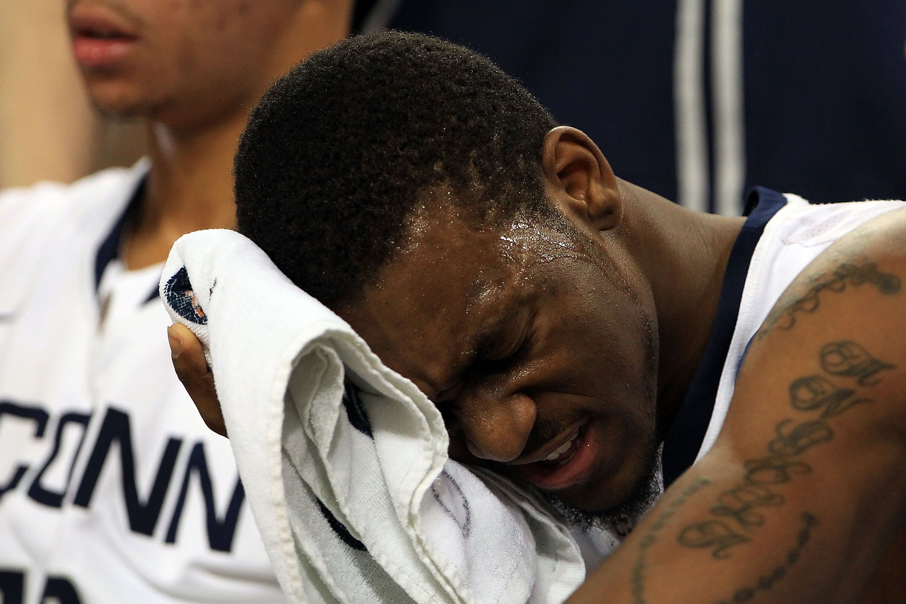 HOUSTON, TX - APRIL 04:  Kemba Walker #15 of the Connecticut Huskies wipes his face on the bench against the Butler Bulldogs during the National Championship Game of the 2011 NCAA Division I Men's Basketball Tournament at Reliant Stadium on April 4, 2011