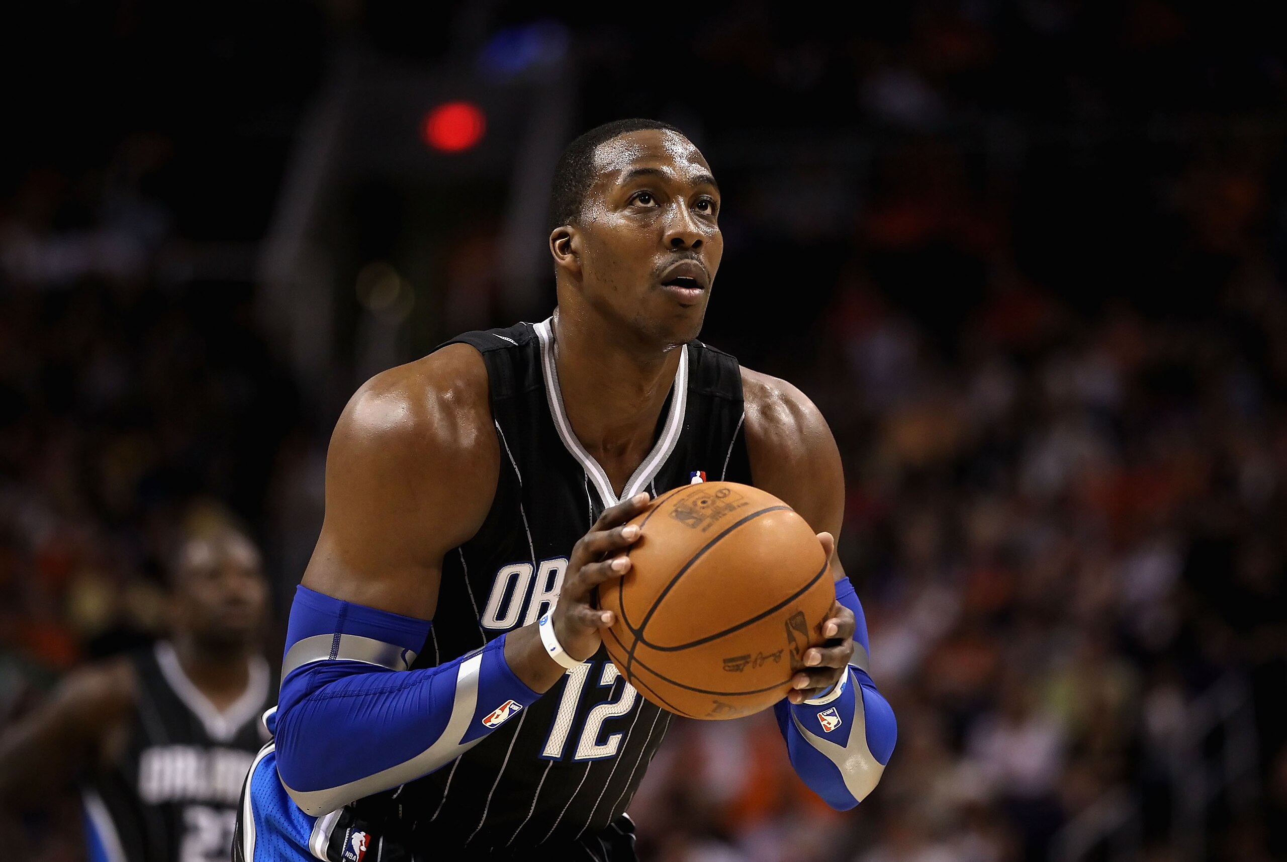 PHOENIX, AZ - MARCH 13: Dwight Howard #12 of the Orlando Magic shoots a free throw shot during the NBA game against the Phoenix Suns at US Airways Center on March 13, 2011 in Phoenix, Arizona. The Magic defeated the Suns 111-88. NOTE TO USER: User expres PHOENIX, AZ - MARCH 13: Dwight Howard #12 of the Orlando Magic shoots a free throw shot during the NBA game against the Phoenix Suns at US Airways Center on March 13, 2011 in Phoenix, Arizona. The Magic defeated the Suns 111-88. NOTE TO USER: User expres