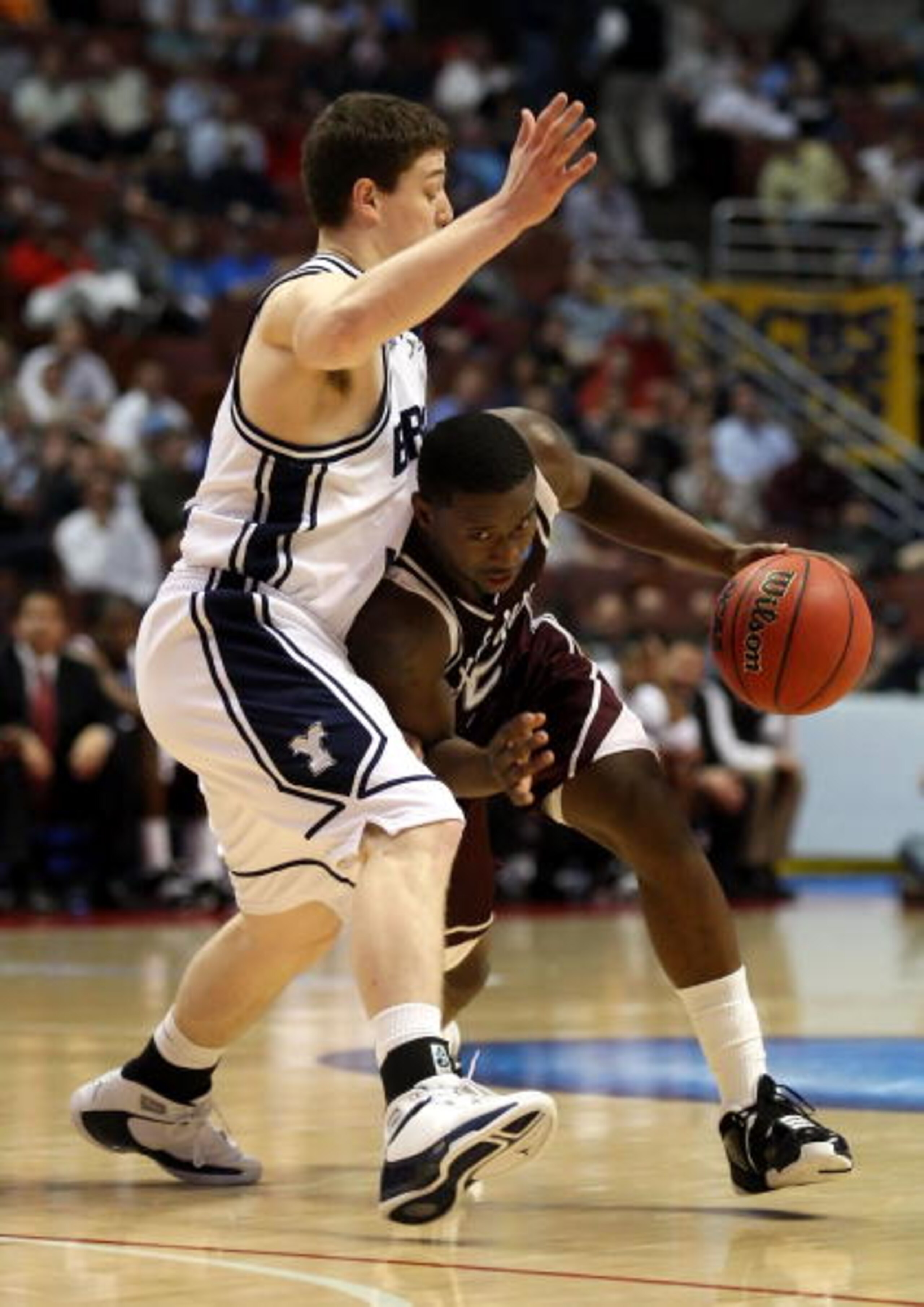 ANAHEIM, CA - MARCH 20:  Donald Sloan #15 of the Texas A&M Aggies dribbles against the defense of Jimmer Fredette of the Brigham Young Cougars during the West Region first round of the NCAA Basketball Tournament at the Honda Center on March 20, 2008 in An
