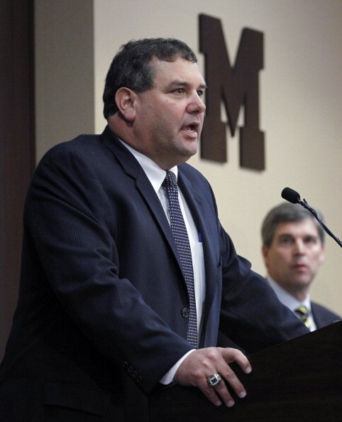 ANN ARBOR, MI - JANUARY 12:  New University of Michigan head football coach Brady Hoke (L) speaks to the media as, Athletic Director Dave Brandon looks on, after introducing Hoke as the nineteenth Michigan head football coach in Michigan history at the Ju