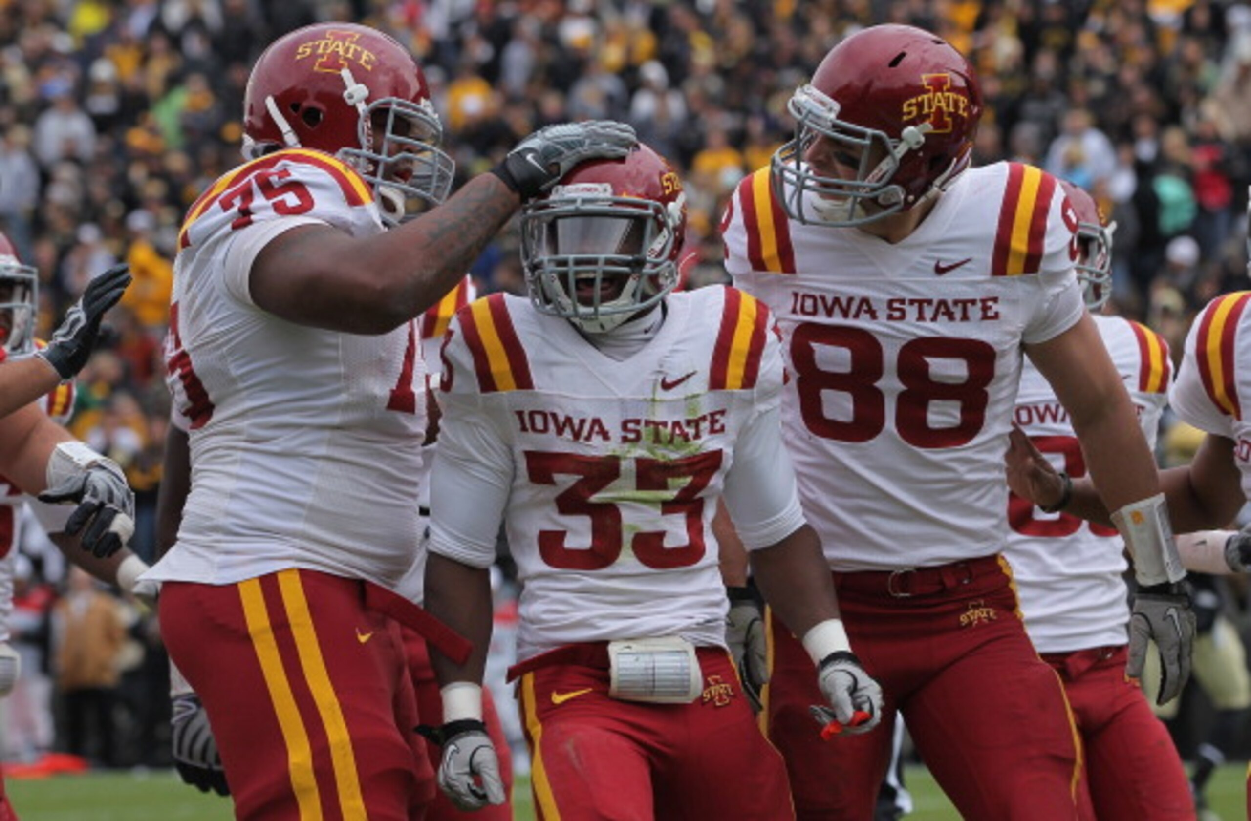 BOULDER, CO - NOVEMBER 13:  Alexander Robinson #33 of the Iowa State Cyclones celebrates his eight yard touchdown run in the second quarter with his teammates against the Colorado Buffaloes at Folsom Field on November 13, 2010 in Boulder, Colorado. Colora