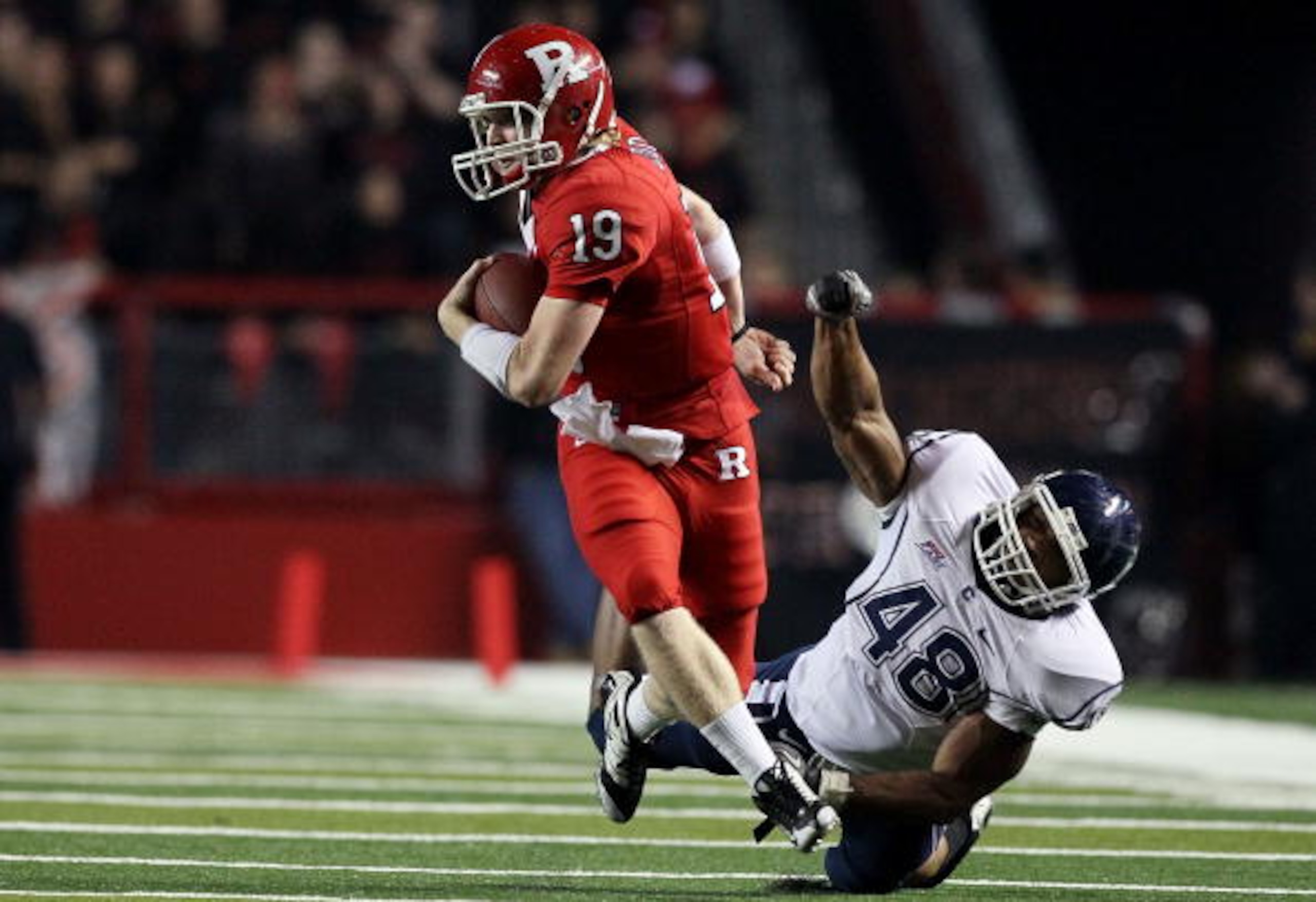 PISCATAWAY, NJ - OCTOBER 08:  Chas Dodd #19 of the Rutgers Scarlet Knights runs the ball against Trevardo Williams #48 of the Connecticut Huskies at Rutgers Stadium on October 8, 2010 in Piscataway, New Jersey.  (Photo by Jim McIsaac/Getty Images)