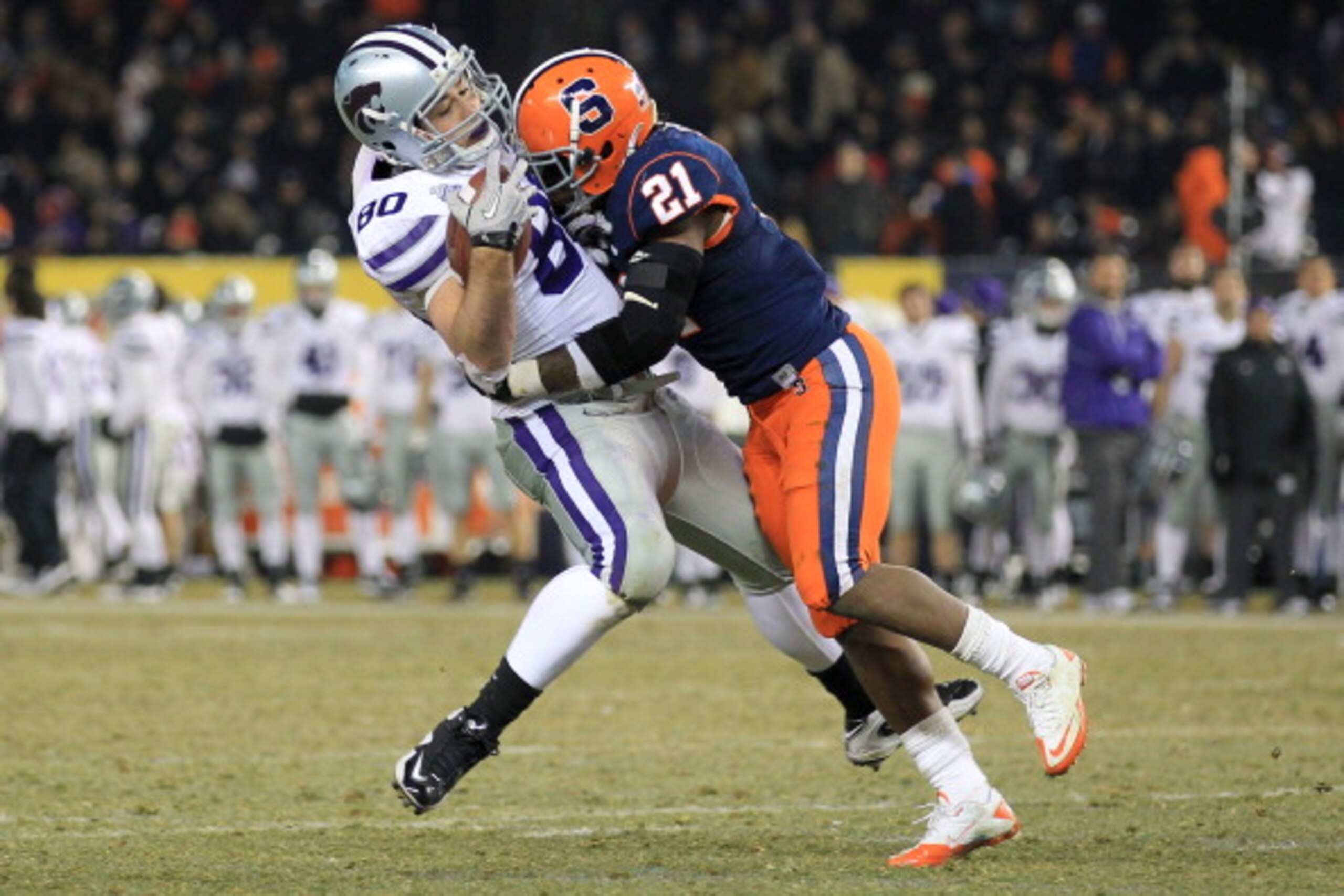 NEW YORK, NY - DECEMBER 30:  Travis Tannahill #80 of the Kansas State Wildcats is tackled by Thomas Shamarko #21 of the Syracuse Orange during the New Era Pinstripe Bowl at Yankee Stadium on December 30, 2010 in New York, New York.  (Photo by Chris McGrat