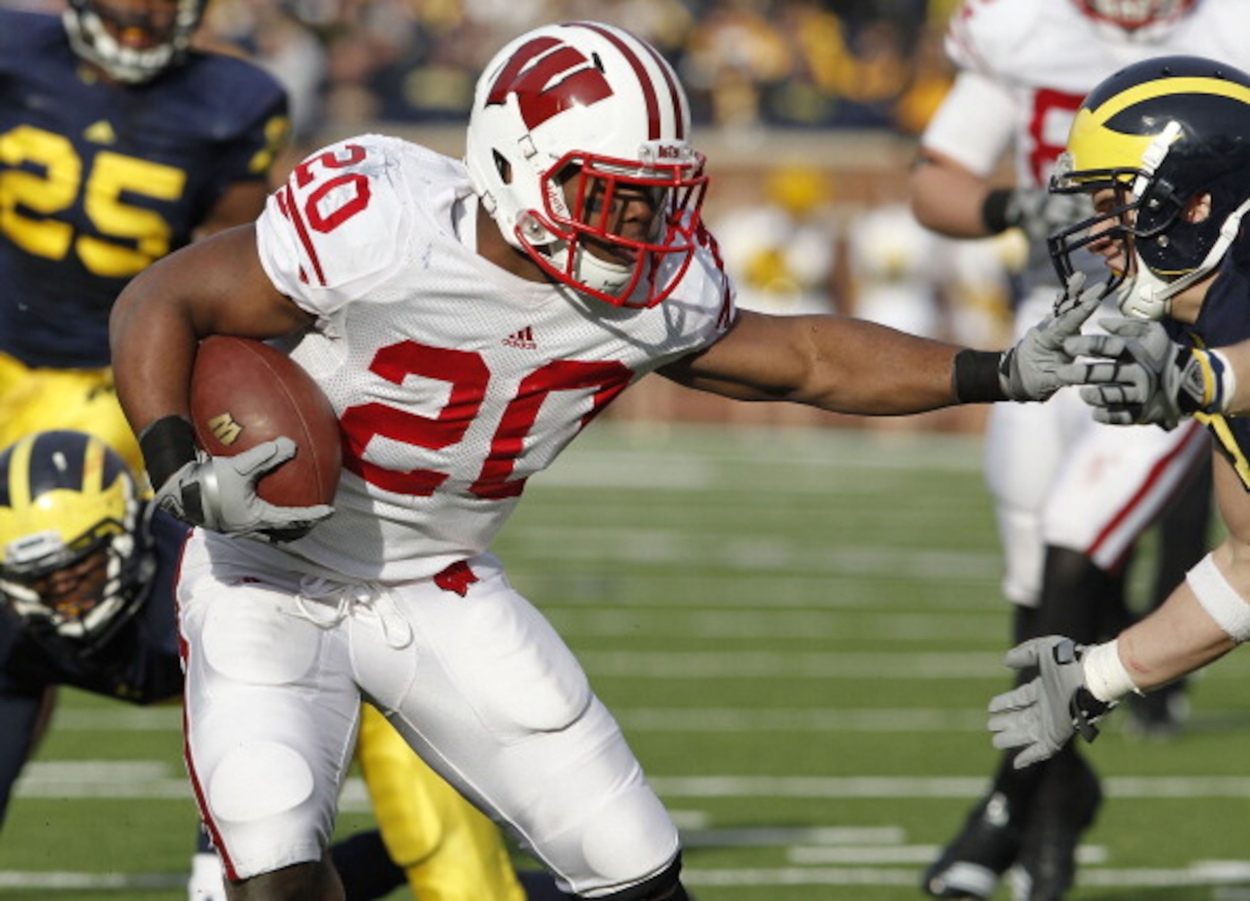 ANN ARBOR, MI - NOVEMBER 20:  James White #20 of the Wisconsin Badgers looks for running room while playing the Michigan Wolverines at Michigan Stadium on November 20, 2010 in Ann Arbor, Michigan. Wisconson won the game 48-28.  (Photo by Gregory Shamus/Ge