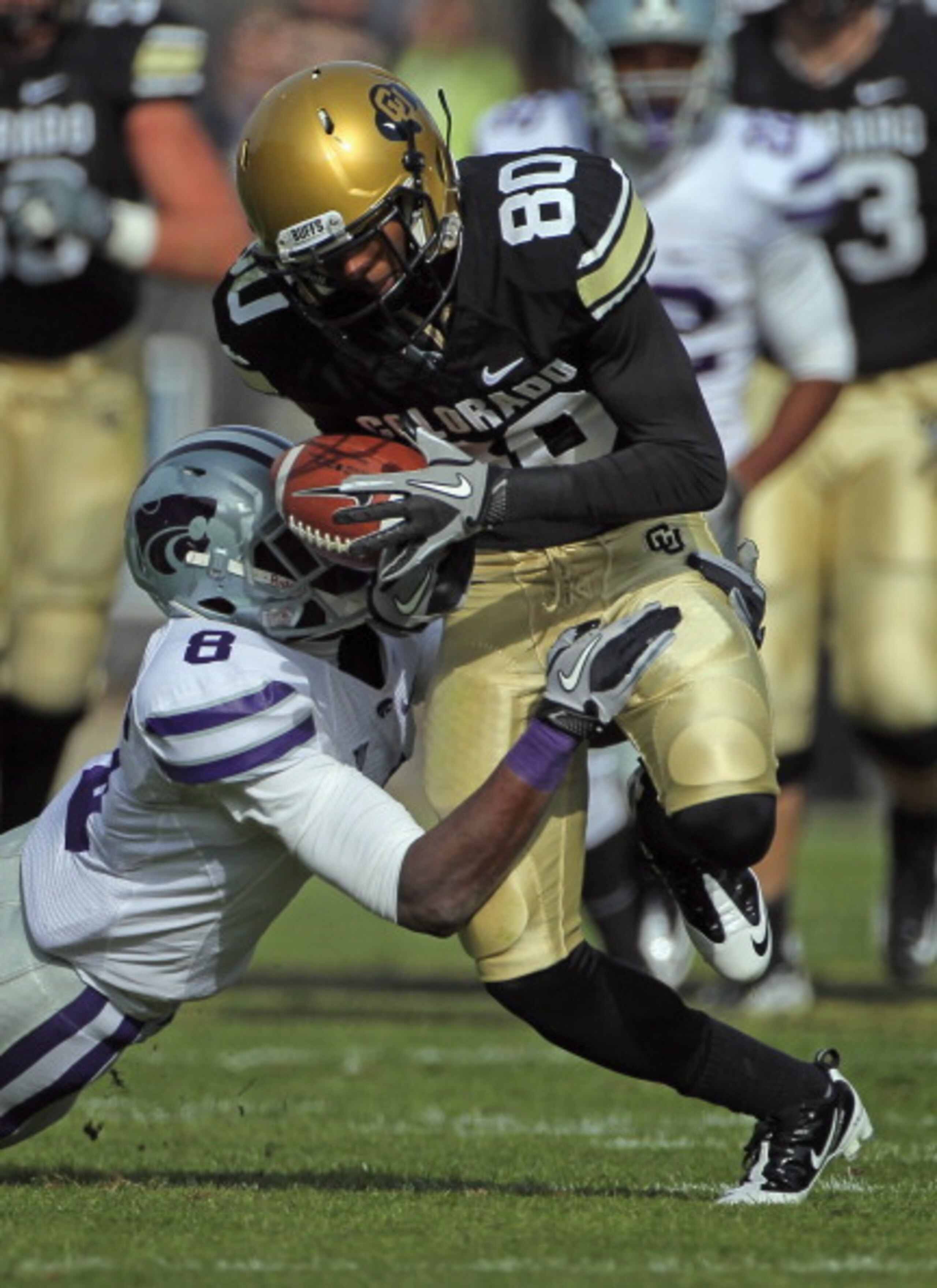 BOULDER, CO - NOVEMBER 20:  Wide receiver Paul Richardson #80 of the Colorado Buffaloes makes a pass reception for a first down as defensive back Stephen Harrison #8 of the Kansas State Wildcats makes the tackle at Folsom Field on November 20, 2010 in Bou