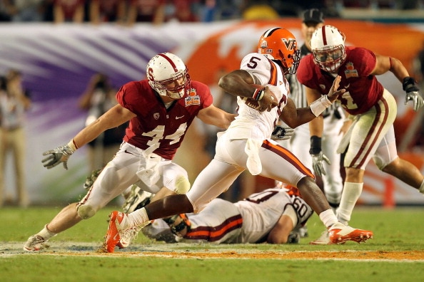 MIAMI, FL - JANUARY 03:  Linebacker Chase Thomas #44 of the Stanford Cardinal attempts to wrap up Tyrod Taylor #5 of the Virginia Tech Hokies during the 2011 Discover Orange Bowl at Sun Life Stadium on January 3, 2011 in Miami, Florida. Stanford won 40-12