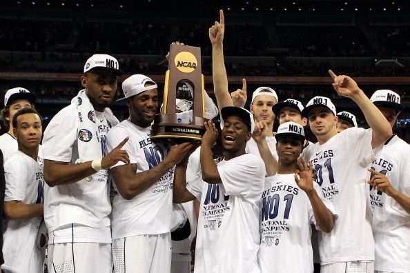 HOUSTON, TX - APRIL 04:  Kemba Walker #15, Alex Oriakhi #34 and Charles Okwandu #35 of the Connecticut Huskies celebrate with their team after defeating the Butler Bulldogs to win the National Championship Game of the 2011 NCAA Division I Men's Basketball