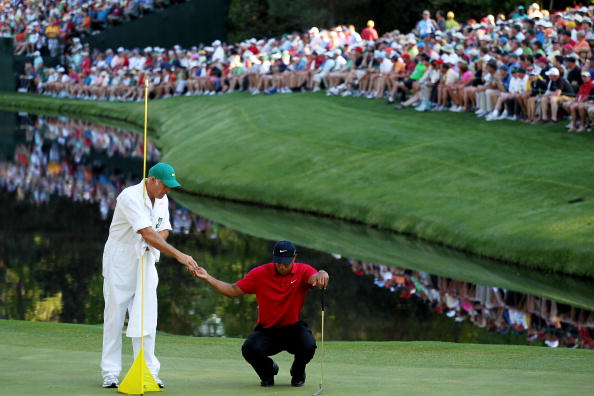 AUGUSTA, GA - APRIL 11:  Tiger Woods (R) lines up a putt with the help of caddie Steve Williams in front of a gallery of fans on the 16th green during the final round of the 2010 Masters Tournament at Augusta National Golf Club on April 11, 2010 in August