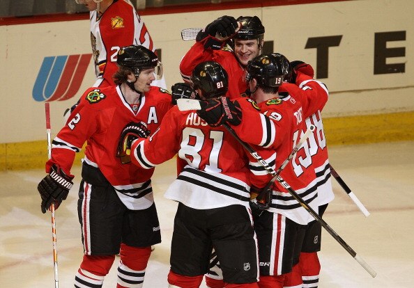 CHICAGO, IL - MARCH 23: Brent Seabrook #7 of the Chicago Blackhawks (facing camera) celebrates his 2nd period goal with teammates (L-R) Duncan Keith #2, Marian Hossa #81, Jonathan Toews #19 and Patrick Kane #88 against the Florida Panthers at the United C