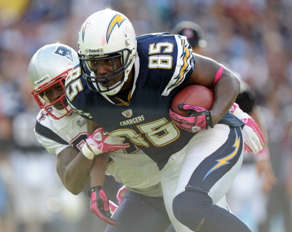 SAN DIEGO - OCTOBER 24:  Antonio Gates #85 of the San Diego Chargers drags Jonathan Wilhite #24 of the New England Patriots after his catch during the fourth quarter at Qualcomm Stadium on October 24, 2010 in San Diego, California.  The Patroits won 23-20