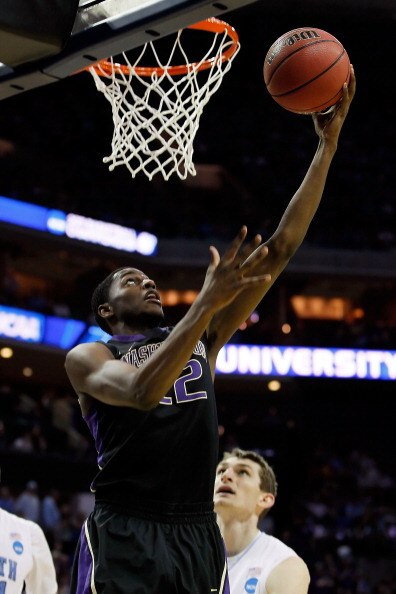 CHARLOTTE, NC - MARCH 20:  Justin Holiday #22 of the Washington Huskies lays the ball up against the North Carolina Tar Heels in the second half during the third round of the 2011 NCAA men's basketball tournament at Time Warner Cable Arena on March 20, 20
