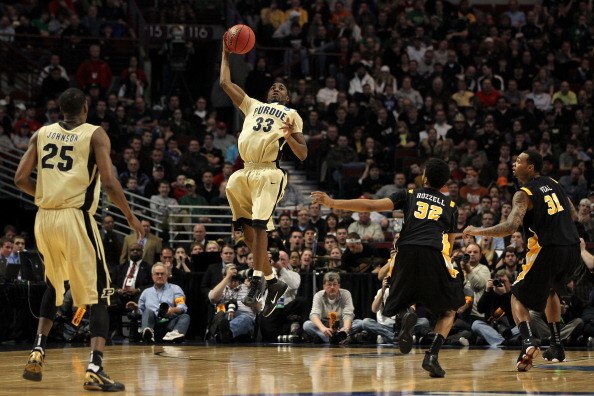 CHICAGO, IL - MARCH 20:  E'Twaun Moore #33 of the Purdue Boilermakers catches the ball as Brandon Rozzell #32 and Toby Veal #31 of the Virginia Commonwealth Rams look on in the first half during the third round of the 2011 NCAA men's basketball tournament