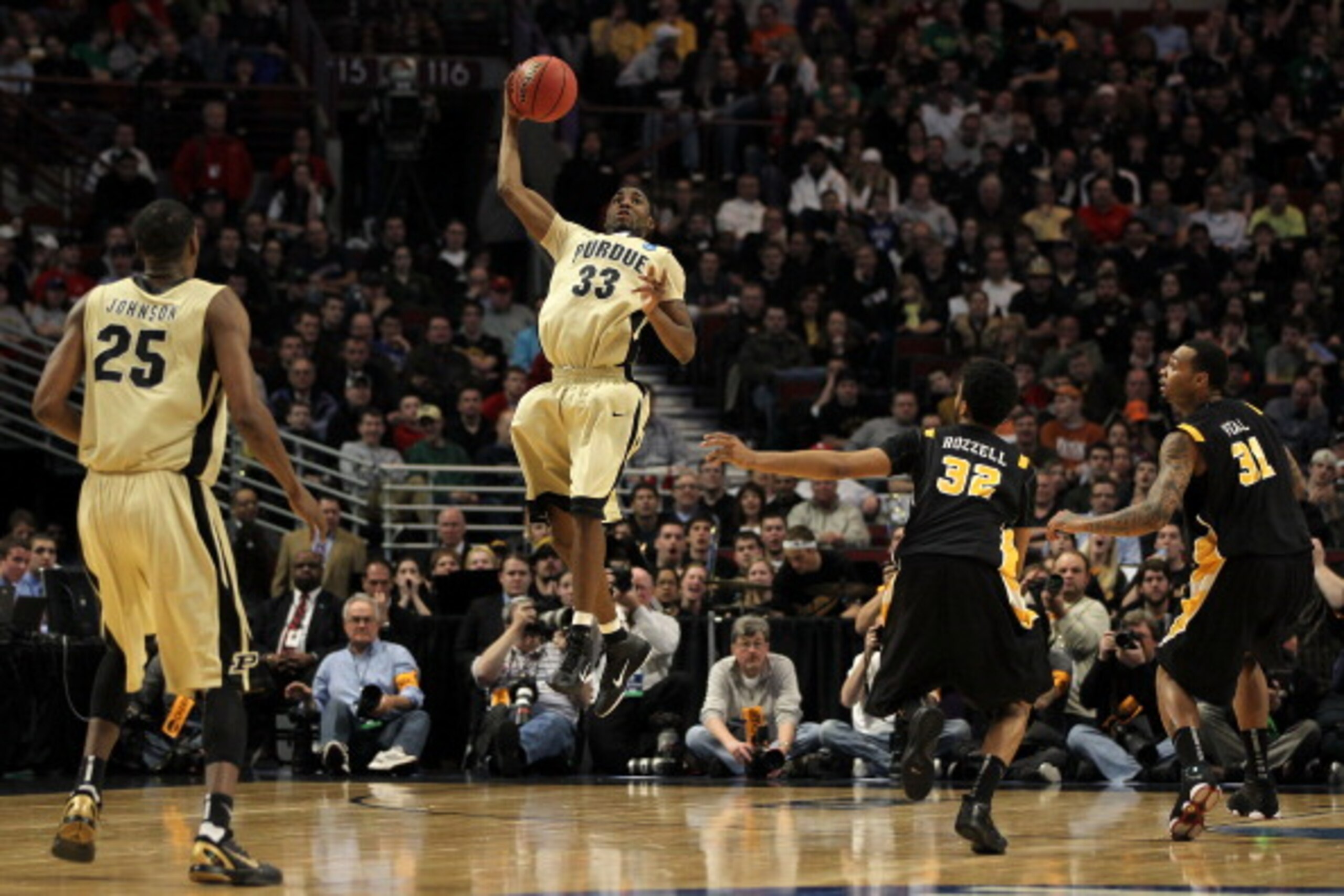 CHICAGO, IL - MARCH 20:  E'Twaun Moore #33 of the Purdue Boilermakers catches the ball as Brandon Rozzell #32 and Toby Veal #31 of the Virginia Commonwealth Rams look on in the first half during the third round of the 2011 NCAA men's basketball tournament