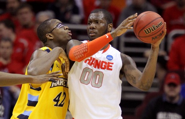 CLEVELAND, OH - MARCH 20: Rick Jackson #00 of the Syracuse Orange handles the ball against Chris Otule #42 of the Marquette Golden Eagles during the third of the 2011 NCAA men's basketball tournament at Quicken Loans Arena on March 20, 2011 in Cleveland, 