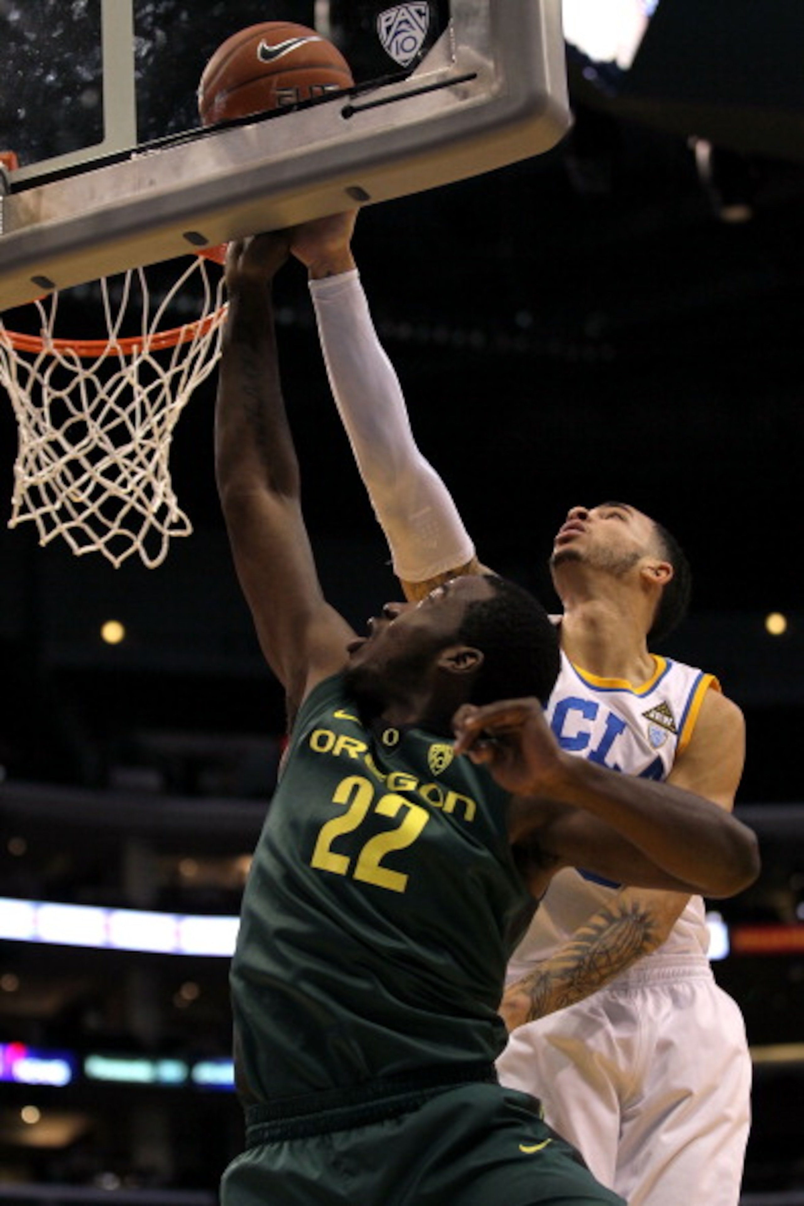 LOS ANGELES, CA - MARCH 10: Teondre Williams #22 of the Oregon Ducks lays the ball up in front of Tyler Honeycutt #23 of the UCLA Bruins in the first half in the quarterfinals of the 2011 Pacific Life Pac-10 Men's Basketball Tournament at Staples Center LOS ANGELES, CA - MARCH 10: Teondre Williams #22 of the Oregon Ducks lays the ball up in front of Tyler Honeycutt #23 of the UCLA Bruins in the first half in the quarterfinals of the 2011 Pacific Life Pac-10 Men's Basketball Tournament at Staples Center