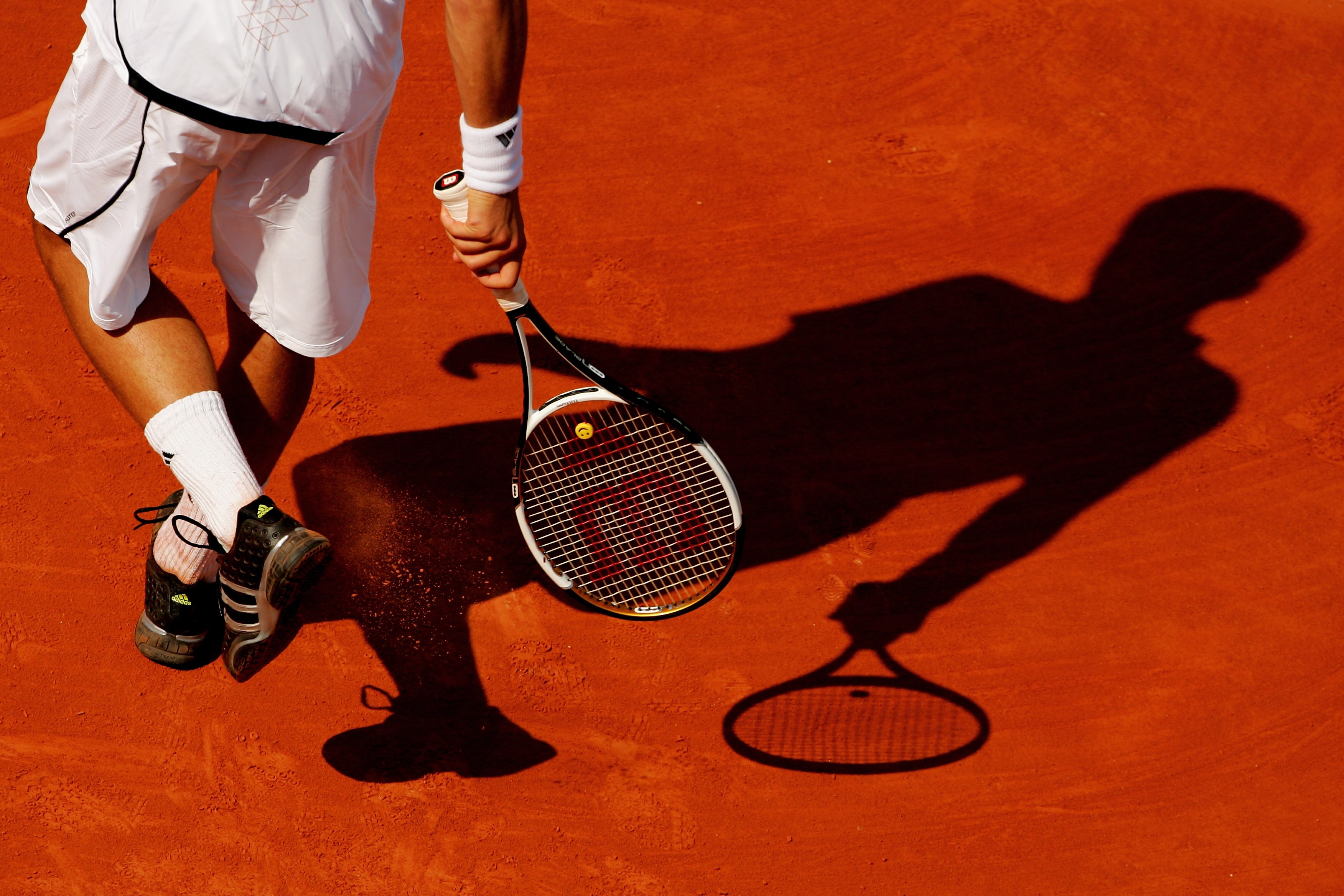 PARIS - JUNE 02:  Novak Djokovic of Serbia clears the clay from his shoes in his game against Olivier Patience of France during the Men's Singles 3rd round match on day seven of the French Open at Roland Garros on June 2, 2007 in Paris, France.  (Photo by