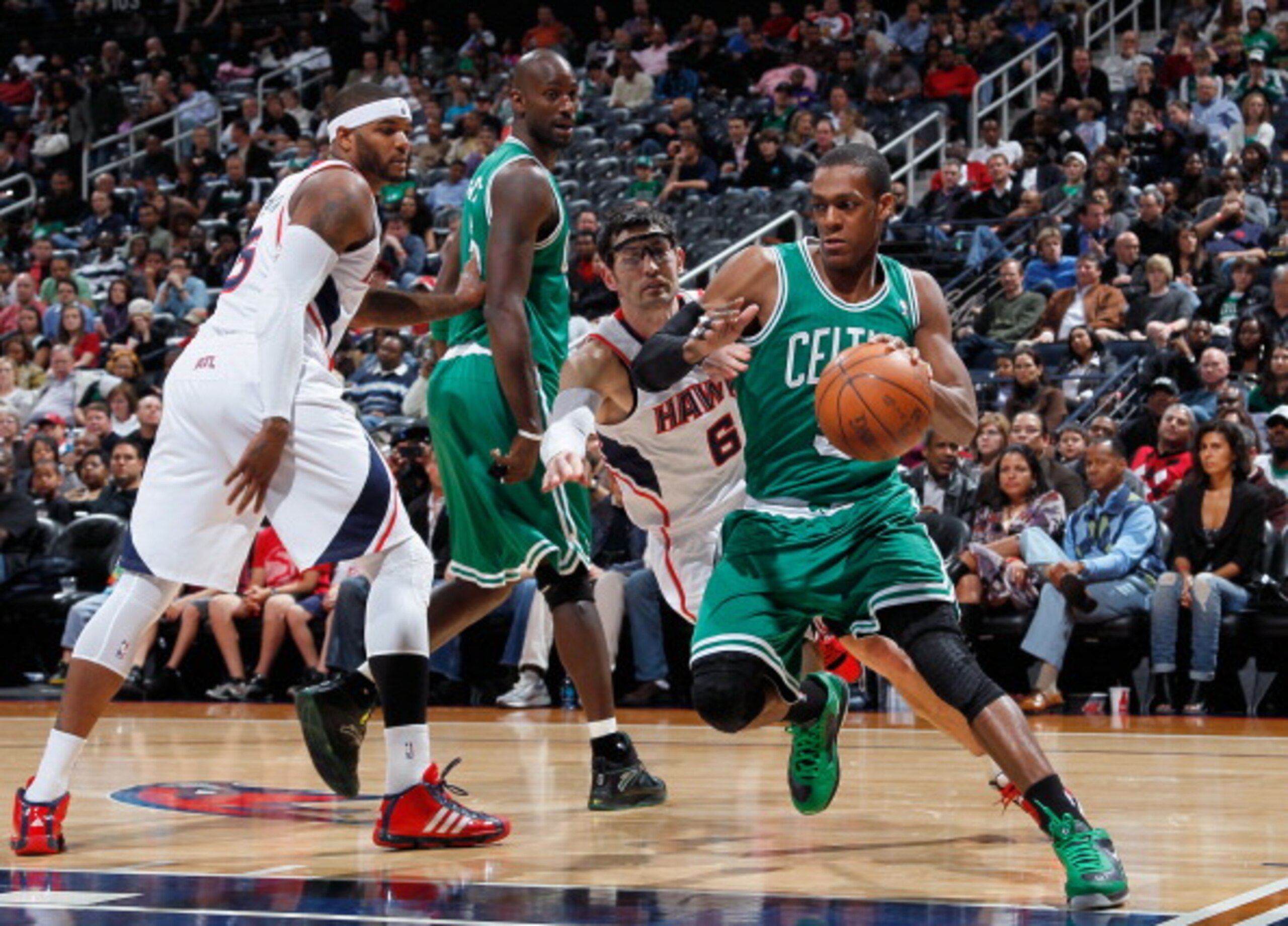 ATLANTA, GA - APRIL 01:  Rajon Rondo #9 of the Boston Celtics against Kirk Hinrich #6 of the Atlanta Hawks at Philips Arena on April 1, 2011 in Atlanta, Georgia.  NOTE TO USER: User expressly acknowledges and agrees that, by downloading and/or using this 