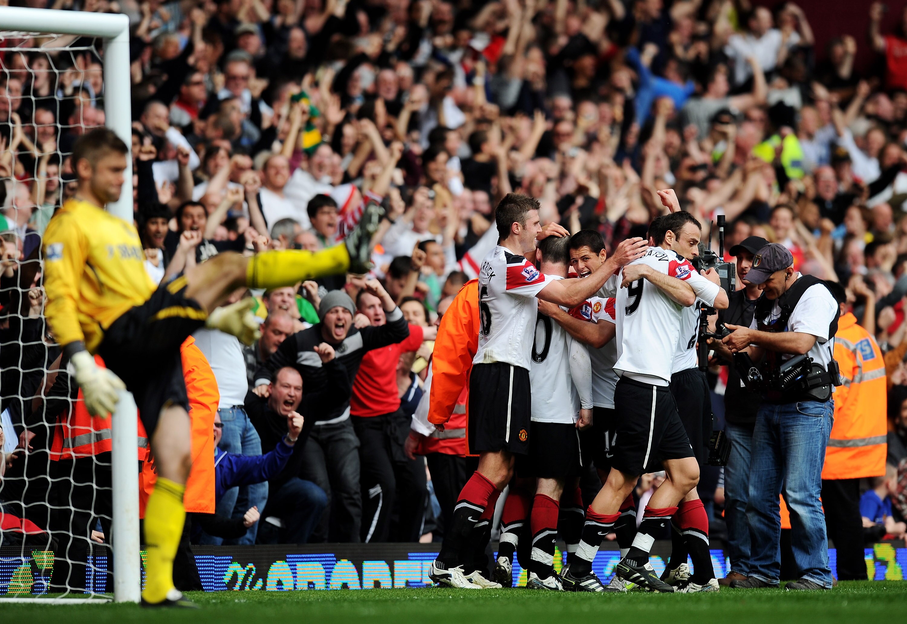 LONDON, ENGLAND - APRIL 02:  Wayne Rooney of Manchester United is mobbed by team mates after scoring his hat trick during the Barclays Premier League match between West Ham United and Manchester United at the Boleyn Ground on April 2, 2011 in London, Engl