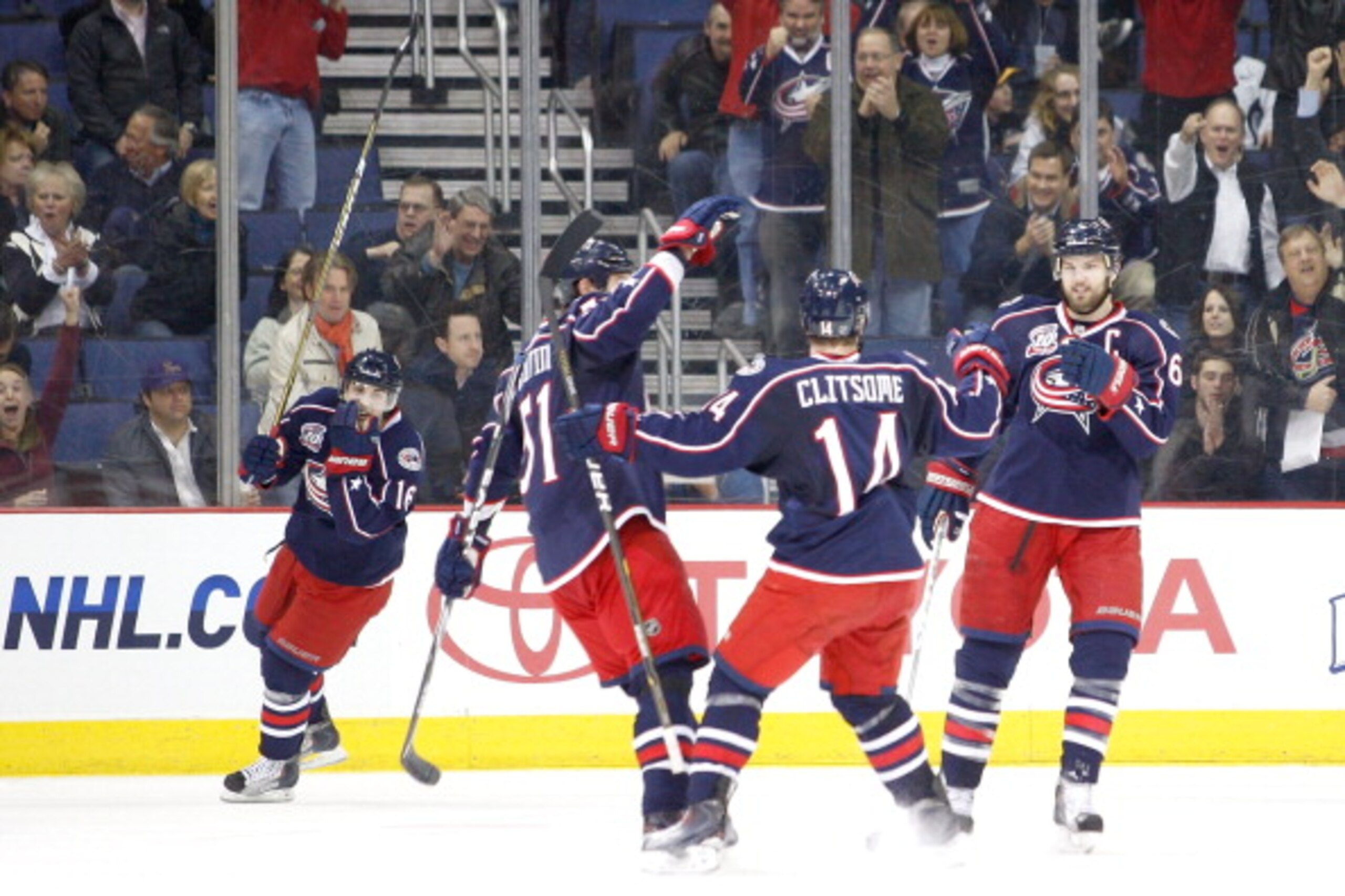 COLUMBUS, OH - MARCH 15:  Grant Clitsome #14 of the Columbus Blue Jackets is congratulated by teammates after scoring a goal against the Boston Bruins during the first period on March 15, 2011 at Nationwide Arena in Columbus, Ohio. (Photo by John Grieshop