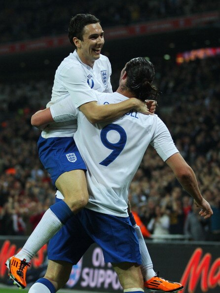 LONDON, ENGLAND - MARCH 29:  Stewart Downing of England (up) congratulates teammate Andy Carroll  after he scores the opening goal during the international friendly match between England and Ghana at Wembley Stadium on March 29, 2011 in London, England.