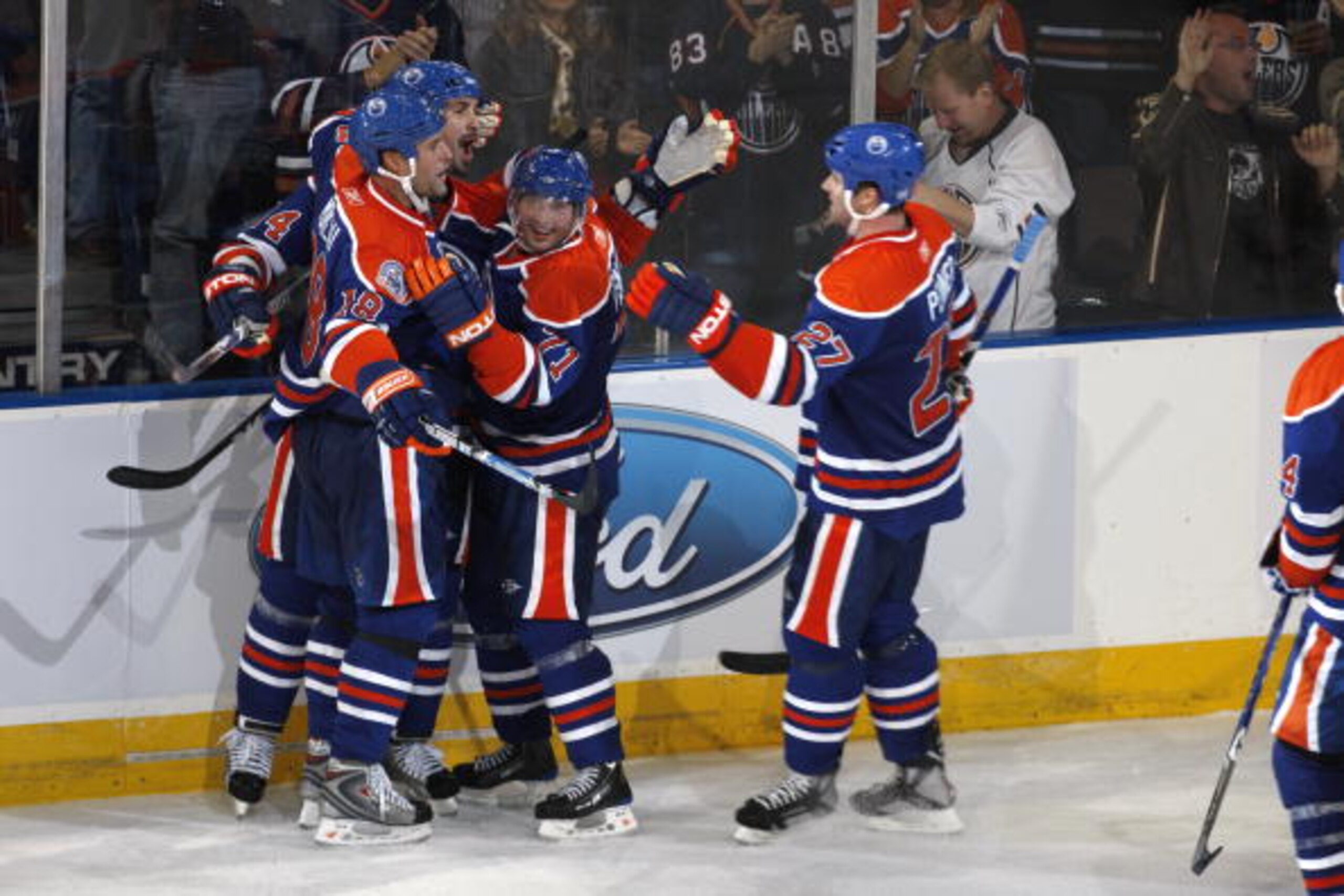 EDMONTON, CANADA - OCTOBER 12:  Ethan Moreau #18 of the Edmonton Oilers celebrates with teammates Sheldon Souray #44, Lubomir Visnovsky #71, and Dustin Penner #27 following his game winning goal with five seconds left in the game vs the  Colorado Avalanch