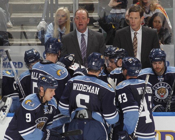 SUNRISE, FL - DECEMBER 27: Head coach Peter DeBoer of the Florida Panthers goes over a play with the team during a time out against the Boston Bruins on December 27, 2010 at the BankAtlantic Center in Sunrise, Florida. The Bruins defeated the Panthers 3-2