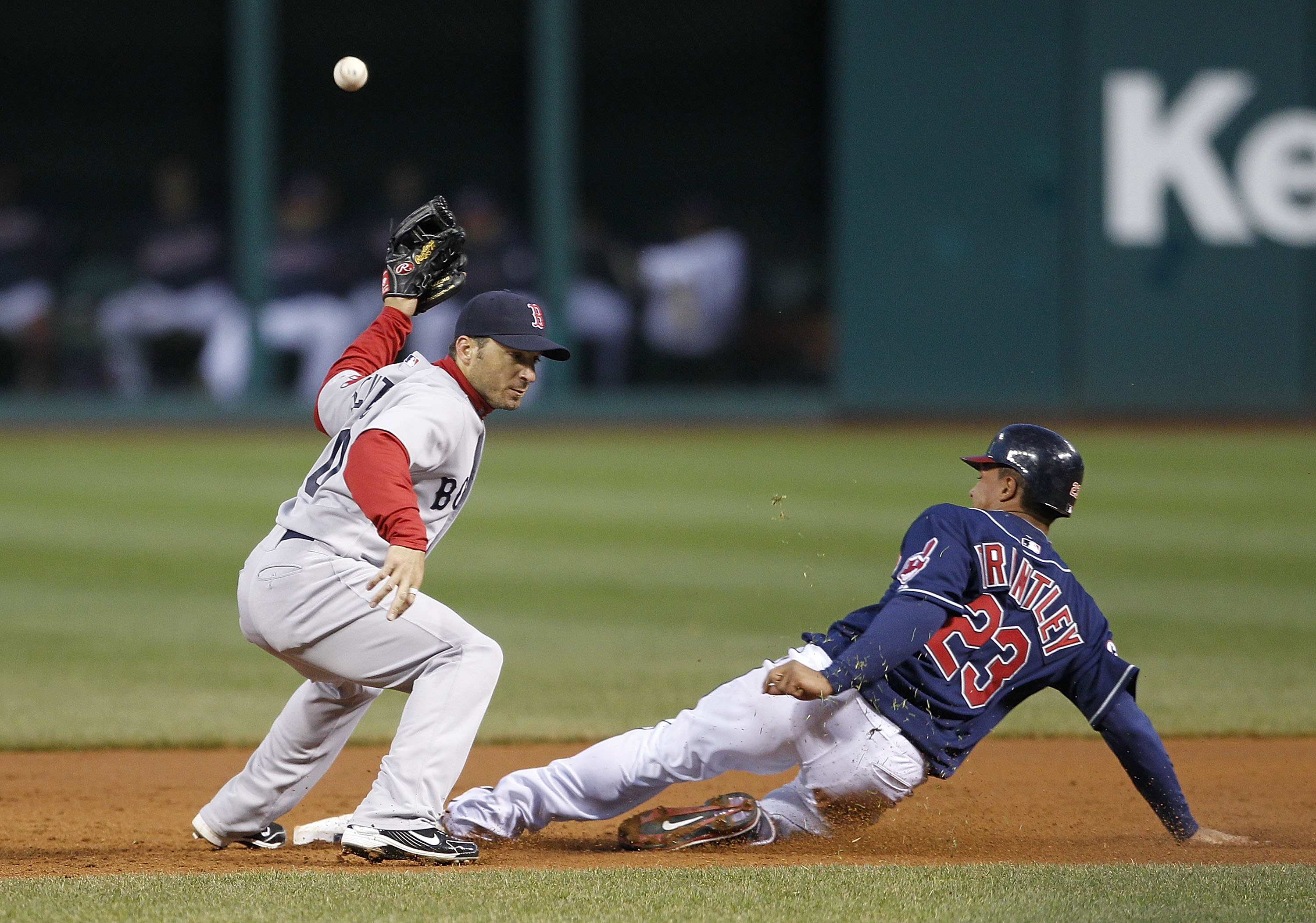 CLEVELAND - APRIL 05: Michael Brantley #23 of the Cleveland Indian steals second base as Marco Scutaro #10 of the Boston Red Sox attempts to make the play during the game at Progressive Field on April 5, 2011 in Cleveland, Ohio. The Indians defeated the R