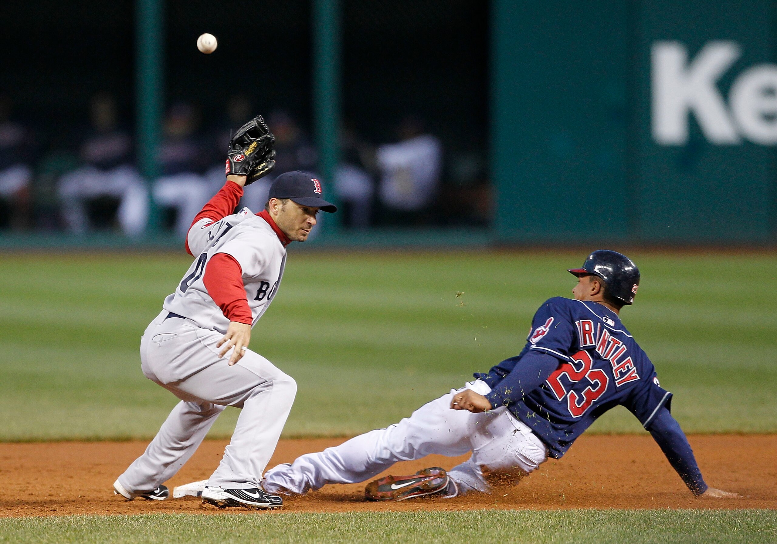 CLEVELAND - APRIL 05: Michael Brantley #23 of the Cleveland Indian steals second base as Marco Scutaro #10 of the Boston Red Sox attempts to make the play during the game at Progressive Field on April 5, 2011 in Cleveland, Ohio. The Indians defeated the R