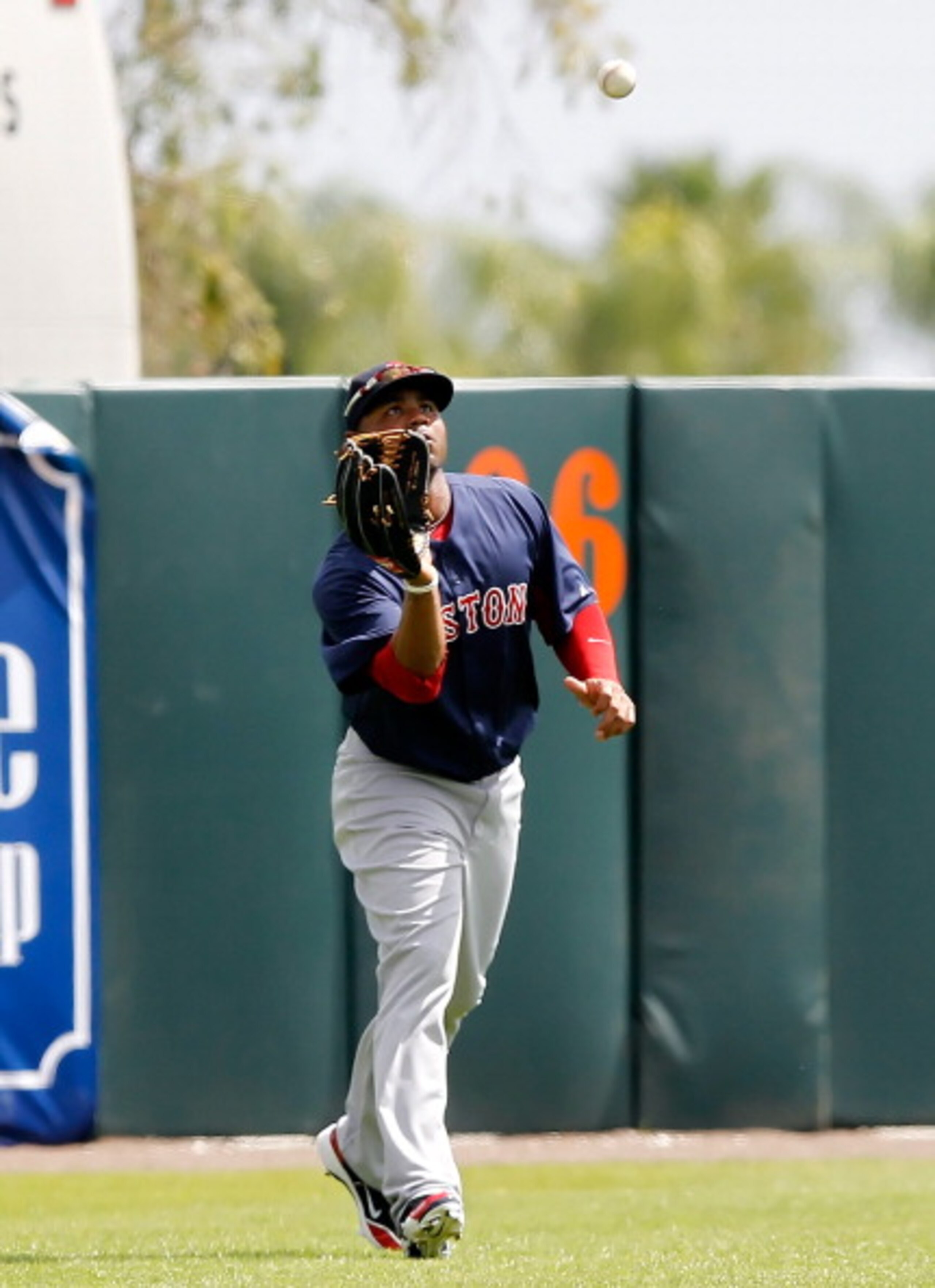 SARASOTA, FL - MARCH 05:  Outfielder Carl Crawford #13 of the Boston Red Sox catches a fly ball against the Baltimore Orioles during a Grapefruit League Spring Training Game at Ed Smith Stadium on March 5, 2011 in Sarasota, Florida.  (Photo by J. Meric/Ge