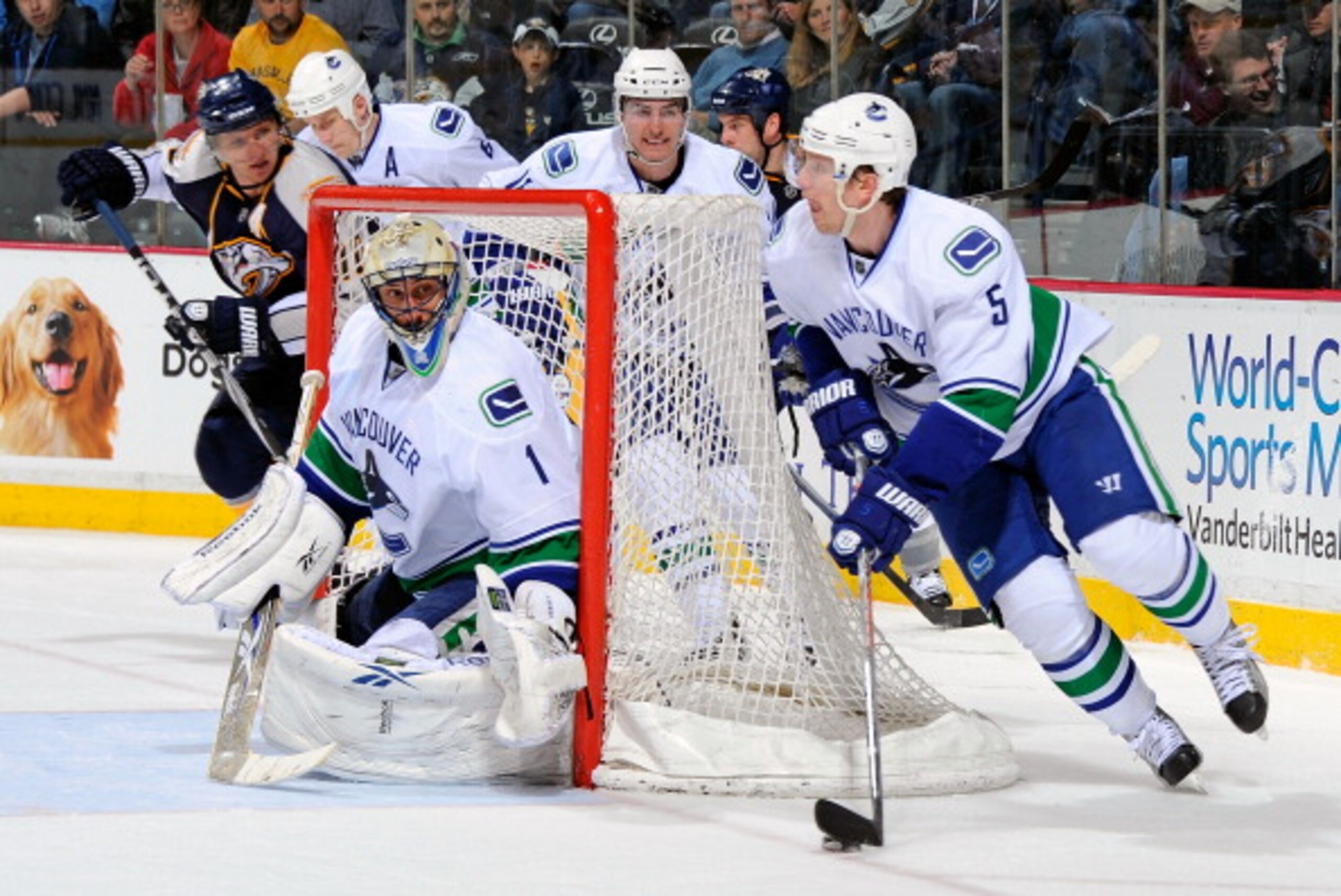 NASHVILLE, TN - MARCH 29: Christian Ehrhoff #5 of the Vancouver Canucks carries the puck behind teammate Roberto Luongo and away from Martin Erat #10 the Nashville Predators on March 29, 2011 at the Bridgestone Arena in Nashville, Tennessee. (Photo by F NASHVILLE, TN - MARCH 29: Christian Ehrhoff #5 of the Vancouver Canucks carries the puck behind teammate Roberto Luongo and away from Martin Erat #10 the Nashville Predators on March 29, 2011 at the Bridgestone Arena in Nashville, Tennessee. (Photo by F