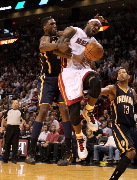 MIAMI, FL - FEBRUARY 08: LeBron James #6 of the Miami Heat is fouled by Roy Hibbert #55 of the Indiana Pacers during a game at American Airlines Arena on February 8, 2011 in Miami, Florida. NOTE TO USER: User expressly acknowledges and agrees that, by dow