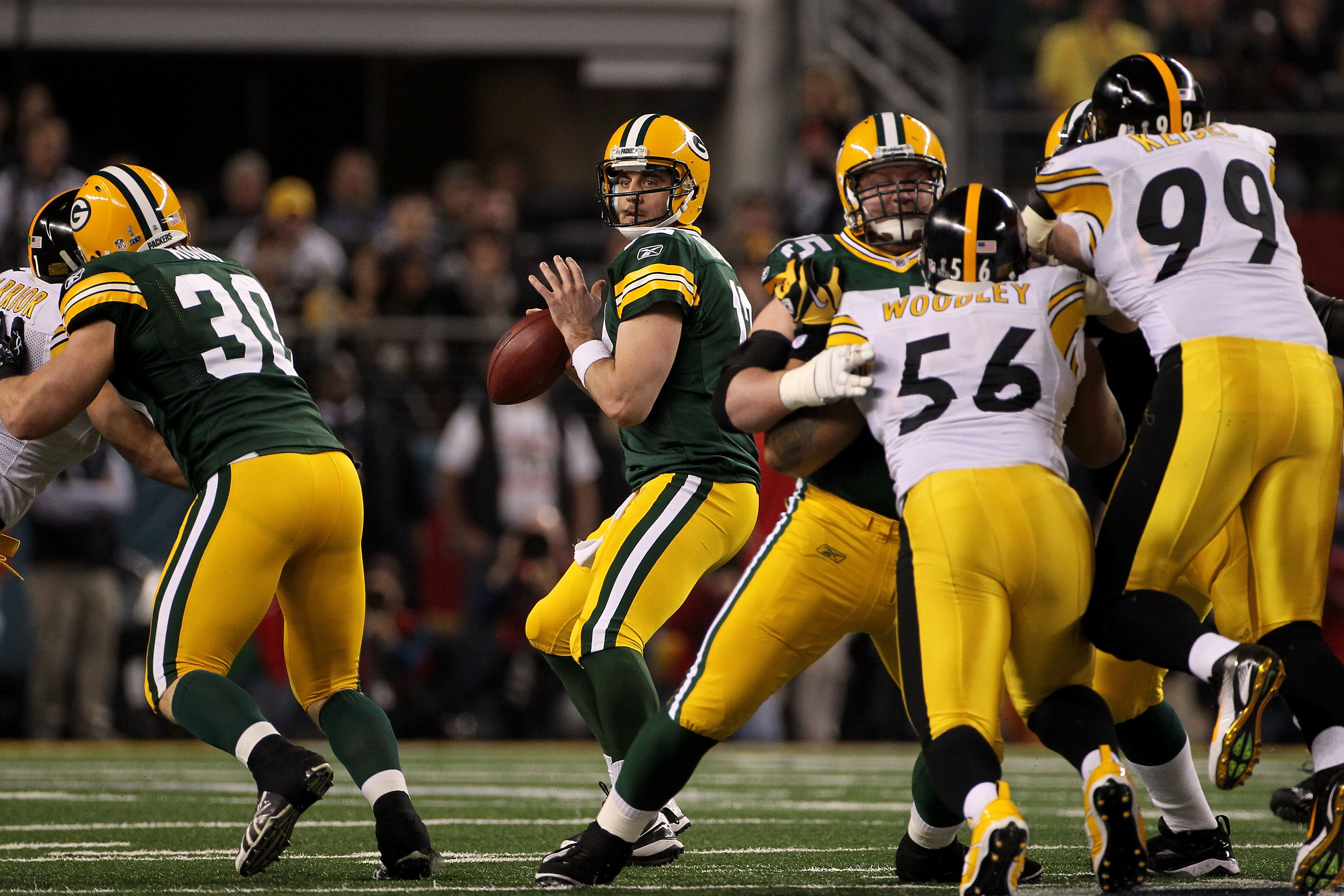 ARLINGTON, TX - FEBRUARY 06:  Aaron Rodgers #12 of the Green Bay Packers drops back against the Pittsburgh Steelers during the first quarter of Super Bowl XLV at Cowboys Stadium on February 6, 2011 in Arlington, Texas.  (Photo by Doug Pensinger/Getty Imag