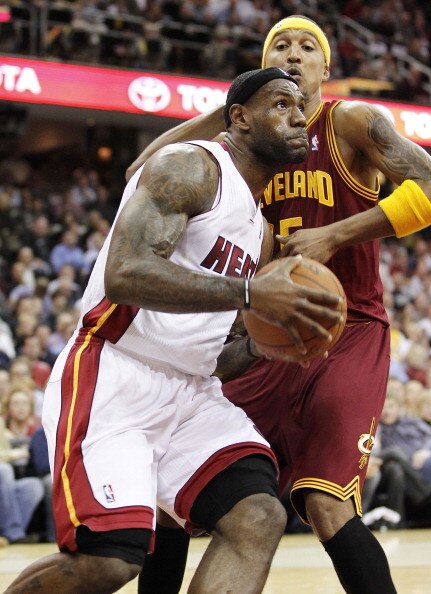 CLEVELAND, OH - DECEMBER 02:  LeBron James #6 of the Miami Heat drives around Jamario Moon #15 of the Cleveland Cavaliers at Quicken Loans Arena on December 2, 2010 in Cleveland, Ohio. NOTE TO USER: User expressly acknowledges and agrees that, by download