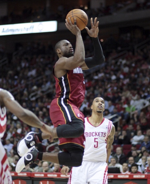 HOUSTON - DECEMBER 29:  Dwyane Wade #3 of the Miami Heat drives past Houston Rockets'  Courtney Lee #5 in the first half at Toyota Center on December 29, 2010 in Houston, Texas.  NOTE TO USER: User expressly acknowledges and agrees that, by downloading an