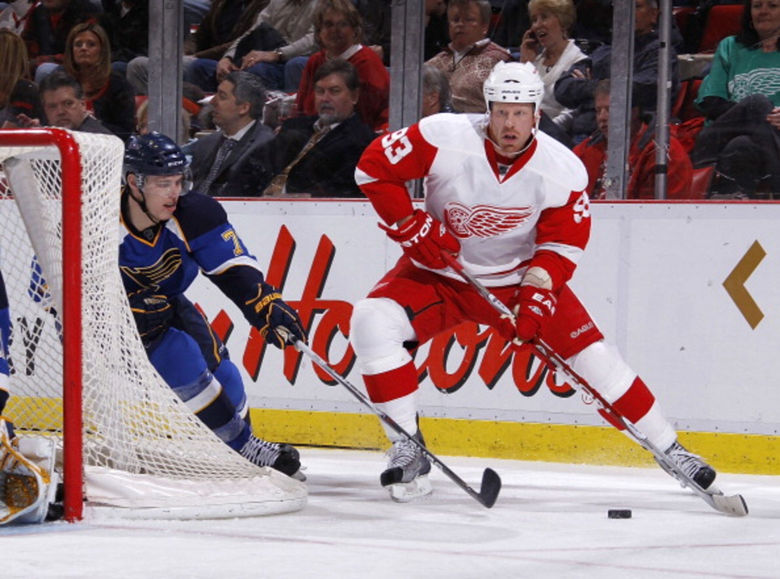DETROIT, MI - MARCH 30: Johan Franzen #93 of the Detroit Red Wings tries to keep the puck from the stick of Adam Cracknell #79 of the St. Louis Blues at Joe Louis Arena on March 30, 2011 in Detroit, Michigan.  (Photo by Gregory Shamus/Getty Images)