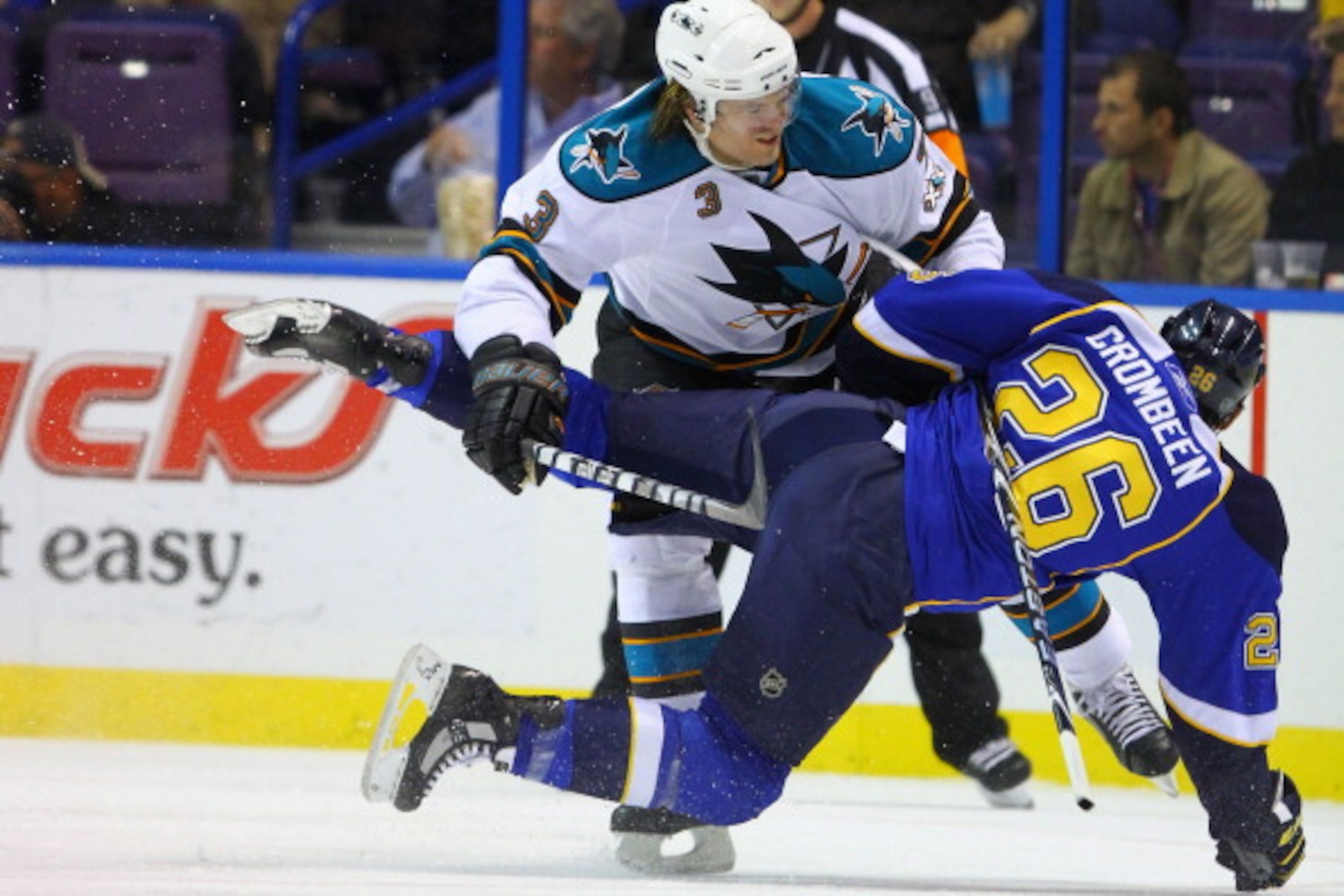 ST. LOUIS - NOVEMBER 4: Douglas Murray #3 of the San Jose Sharks checks B.J. Crombeen #26 of the St. Louis Blues to the ice at the Scottrade Center on November 4, 2010 in St. Louis, Missouri.  (Photo by Dilip Vishwanat/Getty Images)